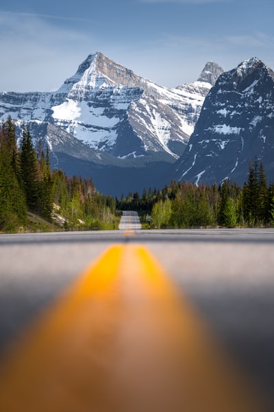 A Long Road Leads To Majestic Snow-capped Mountains And Forests. wallpaper preview