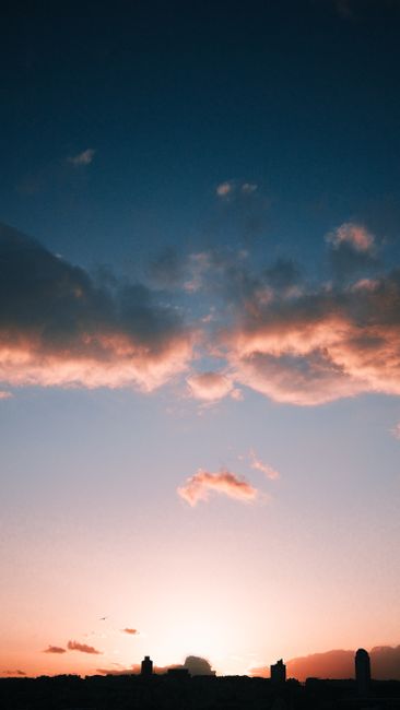 A Striking Sunset Illuminates The City Skyline With Warm Colors, Creating A Stunning Silhouette Effect. wallpaper preview