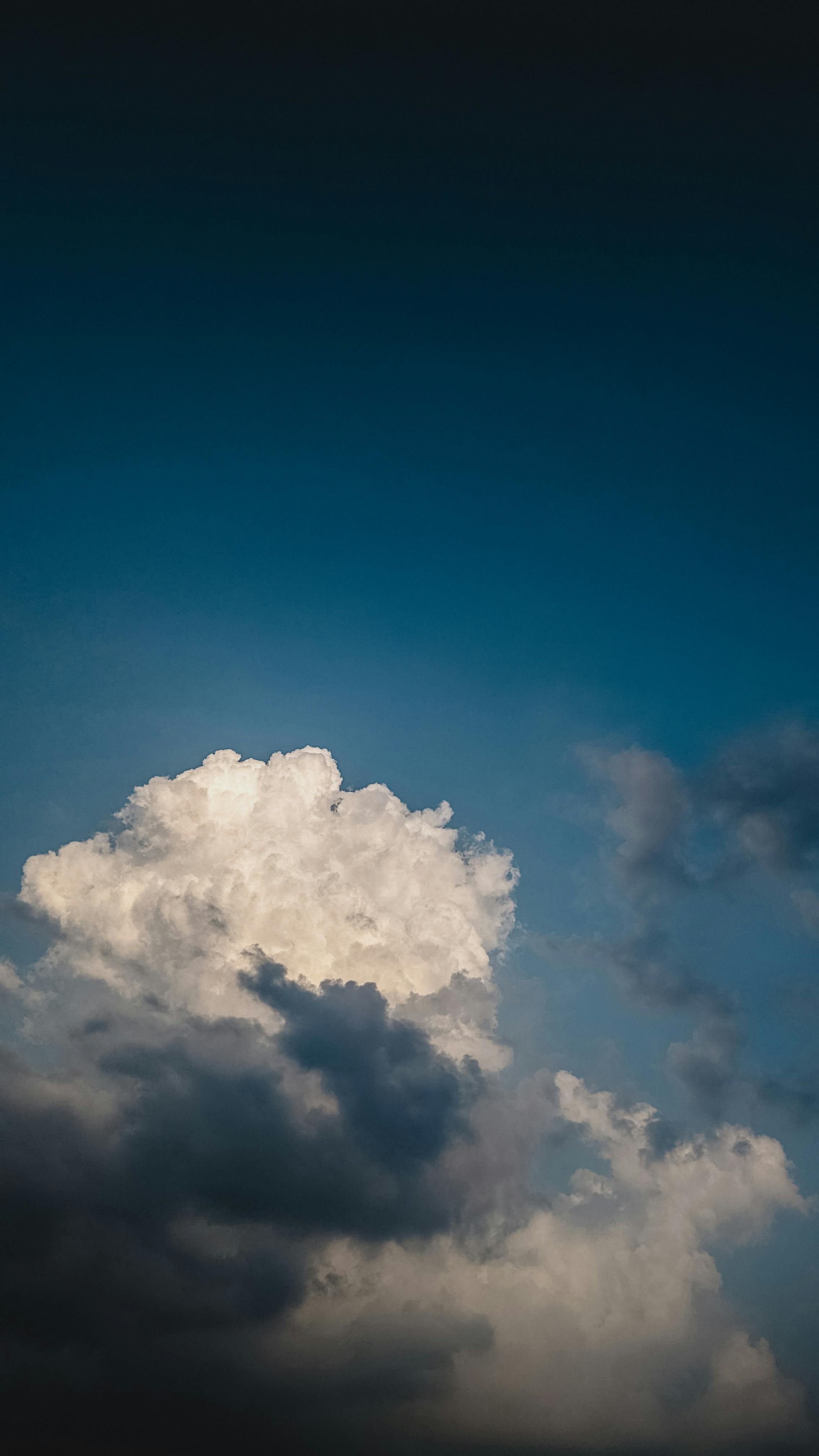 Stunning Image Of Large Clouds Against A Deep Blue Sky, Capturing A Serene And Atmospheric Cloudscape. HD mobile wallpaper