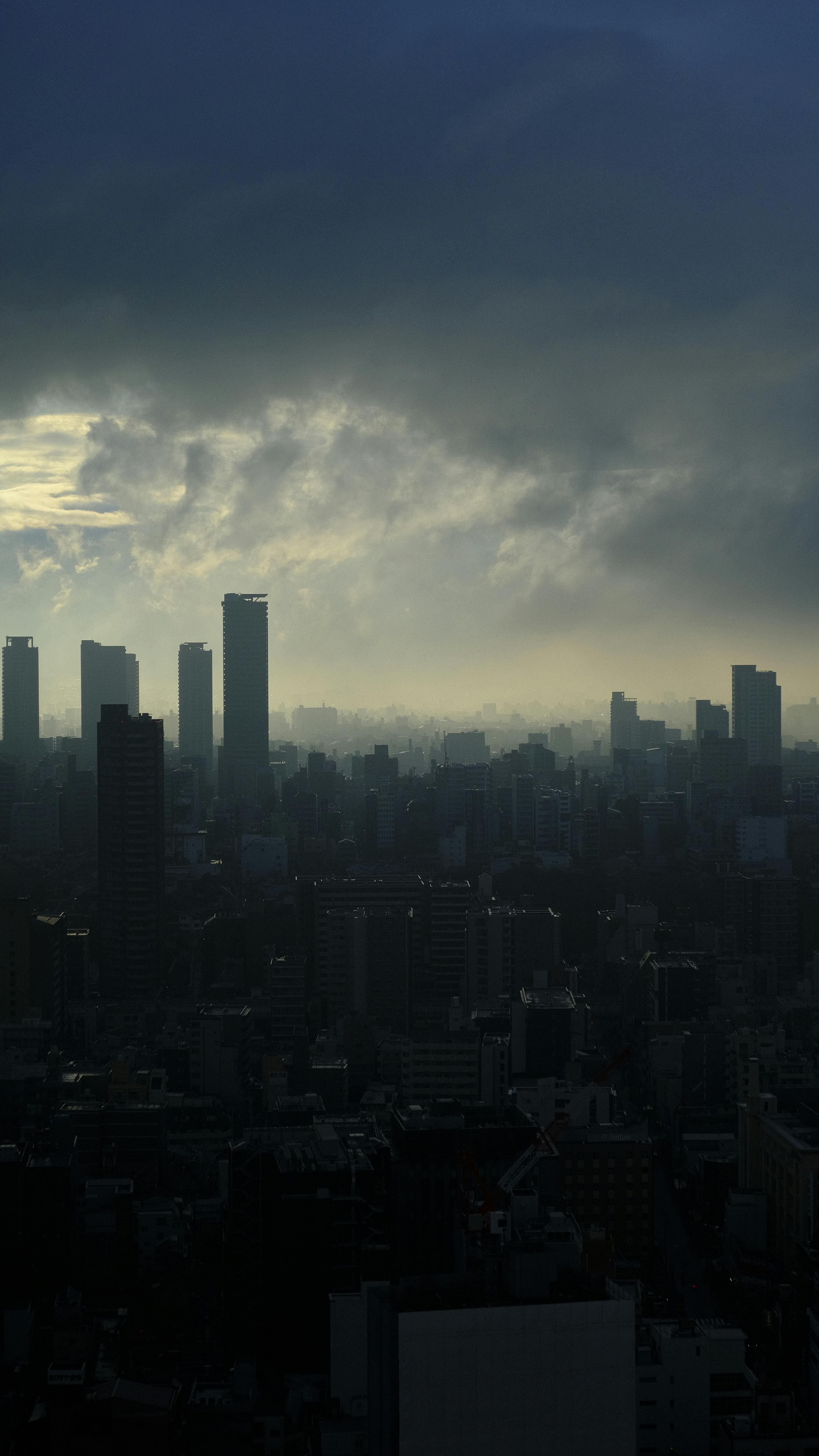 Moody Skyline Of Tokyo, Japan At Dusk With High-rise Buildings Silhouetted Against Dramatic Clouds. HD mobile wallpaper
