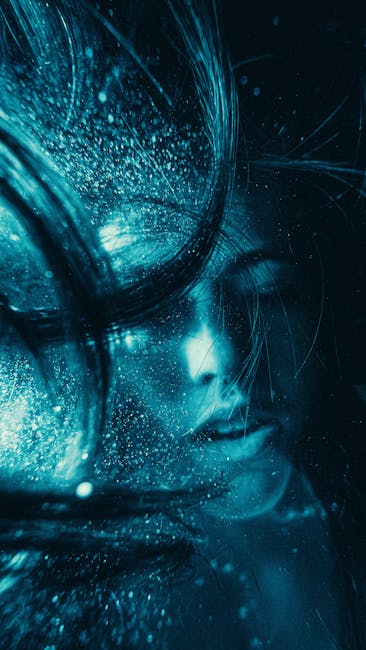 Surreal Underwater Portrait With Blue Hues And Flowing Hair, Creating A Mystical Effect.