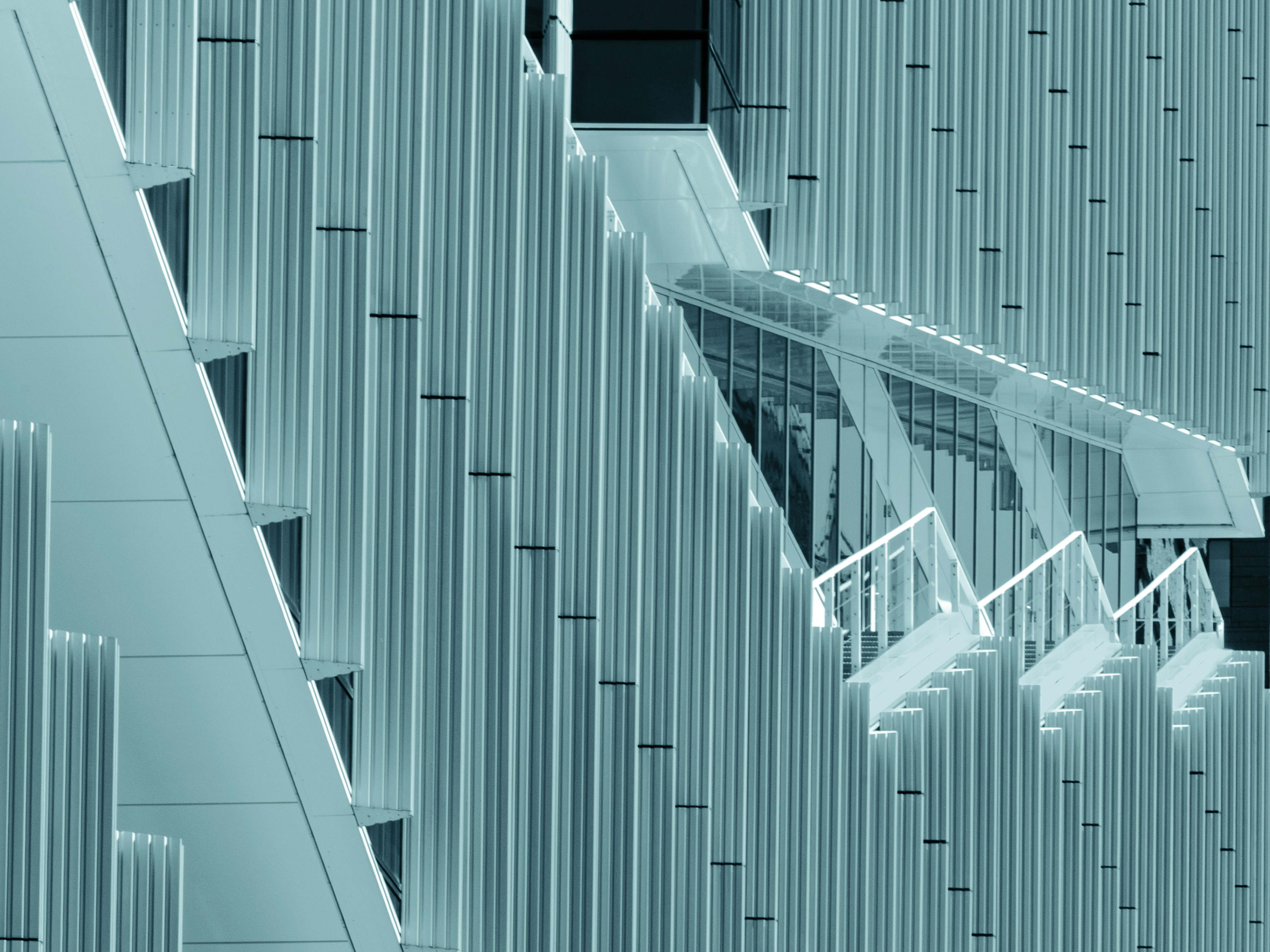 Abstract Architectural Details Of A Contemporary Office Building In Amsterdam's Zuidas District. Repeating Vertical Fins, Geometric Forms, And Subtle Reflections Create A Minimalist Composition Of Rhythm, Structure, And Modern Design. HD mobile wallpaper