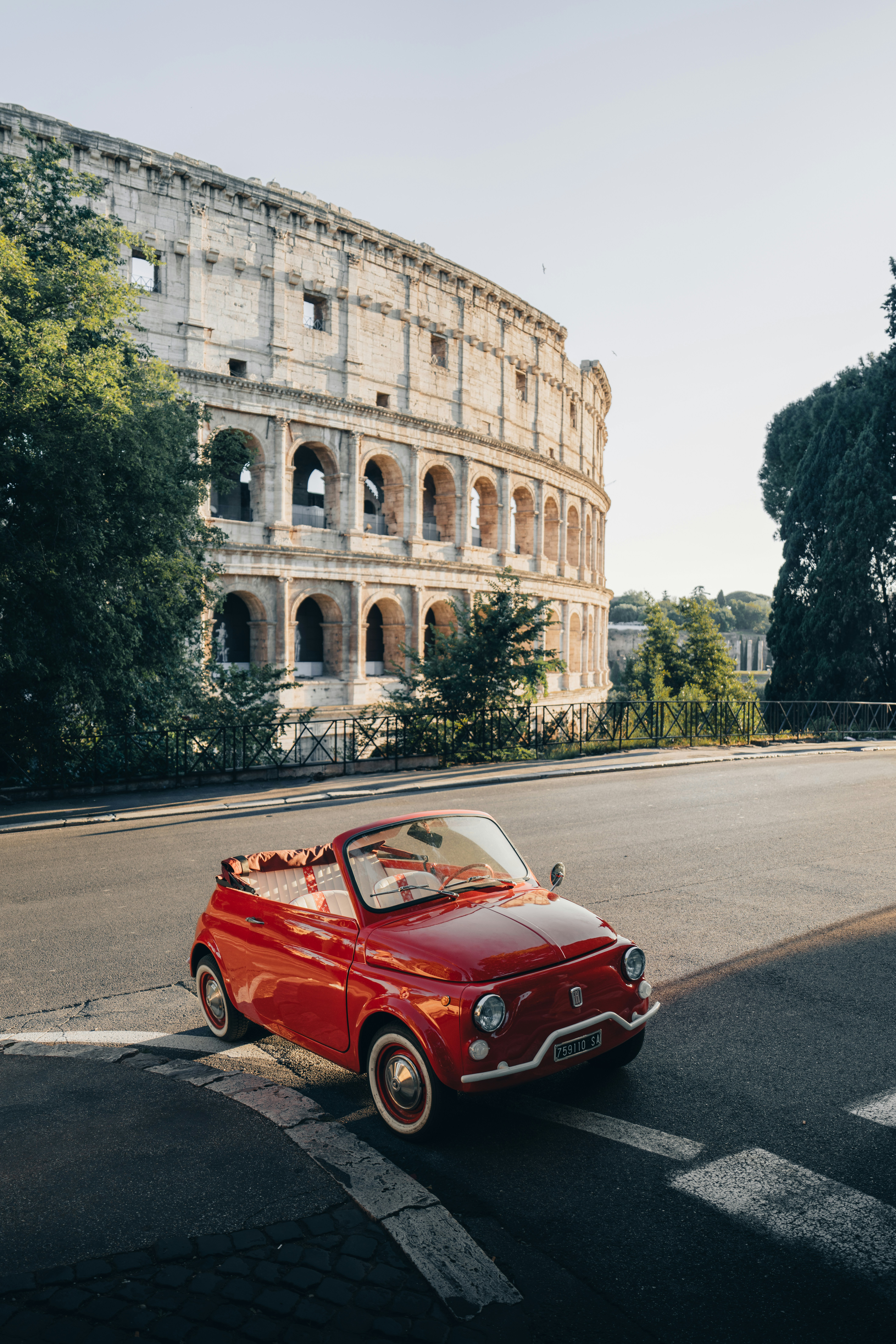 A Red Vintage Car Parked Near The Ancient Roman Colosseum. HD mobile wallpaper