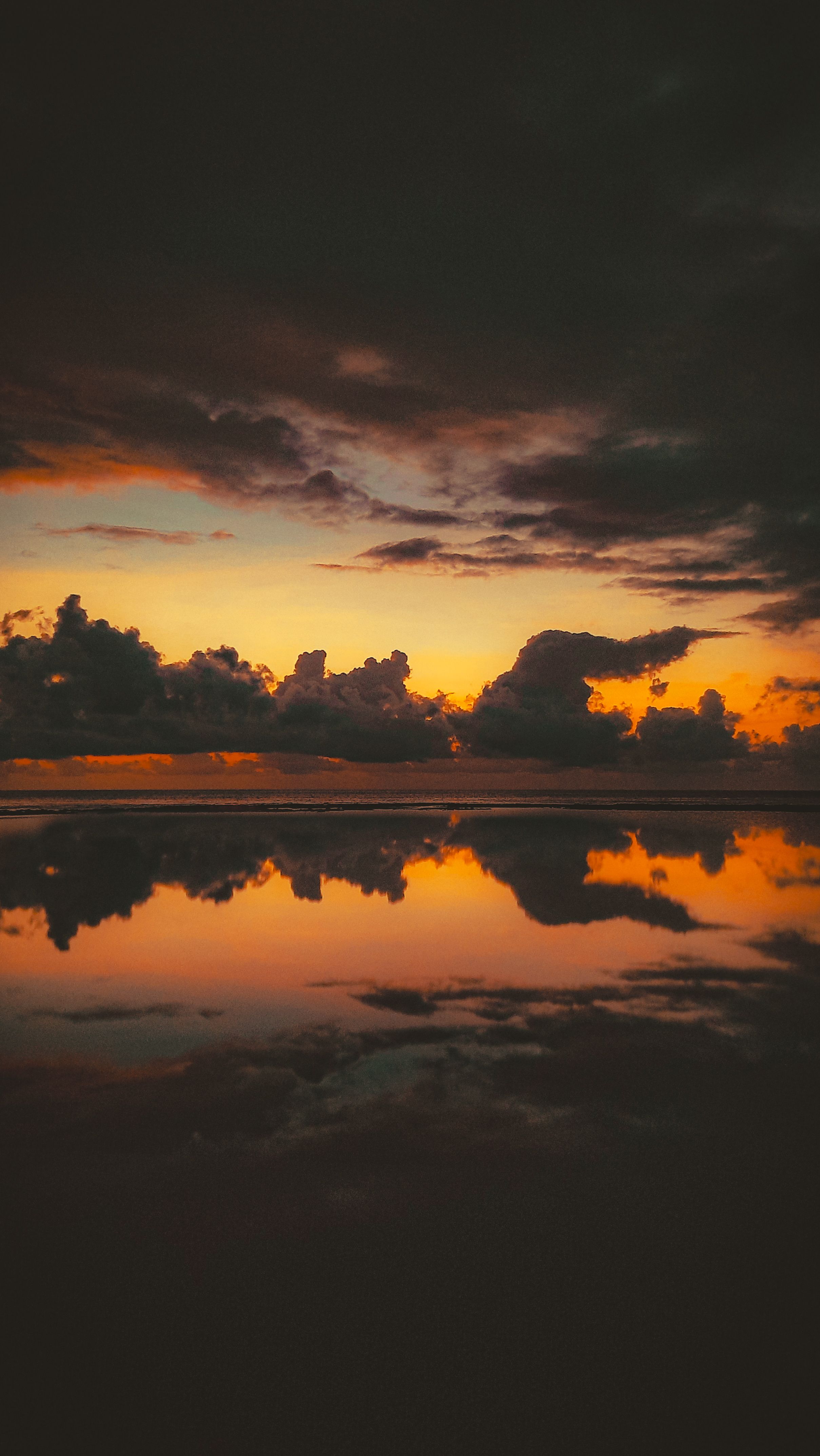 A Breathtaking View Of The Sky And Clouds Reflecting On The Ocean's Surface During The Golden Hour. HD mobile wallpaper