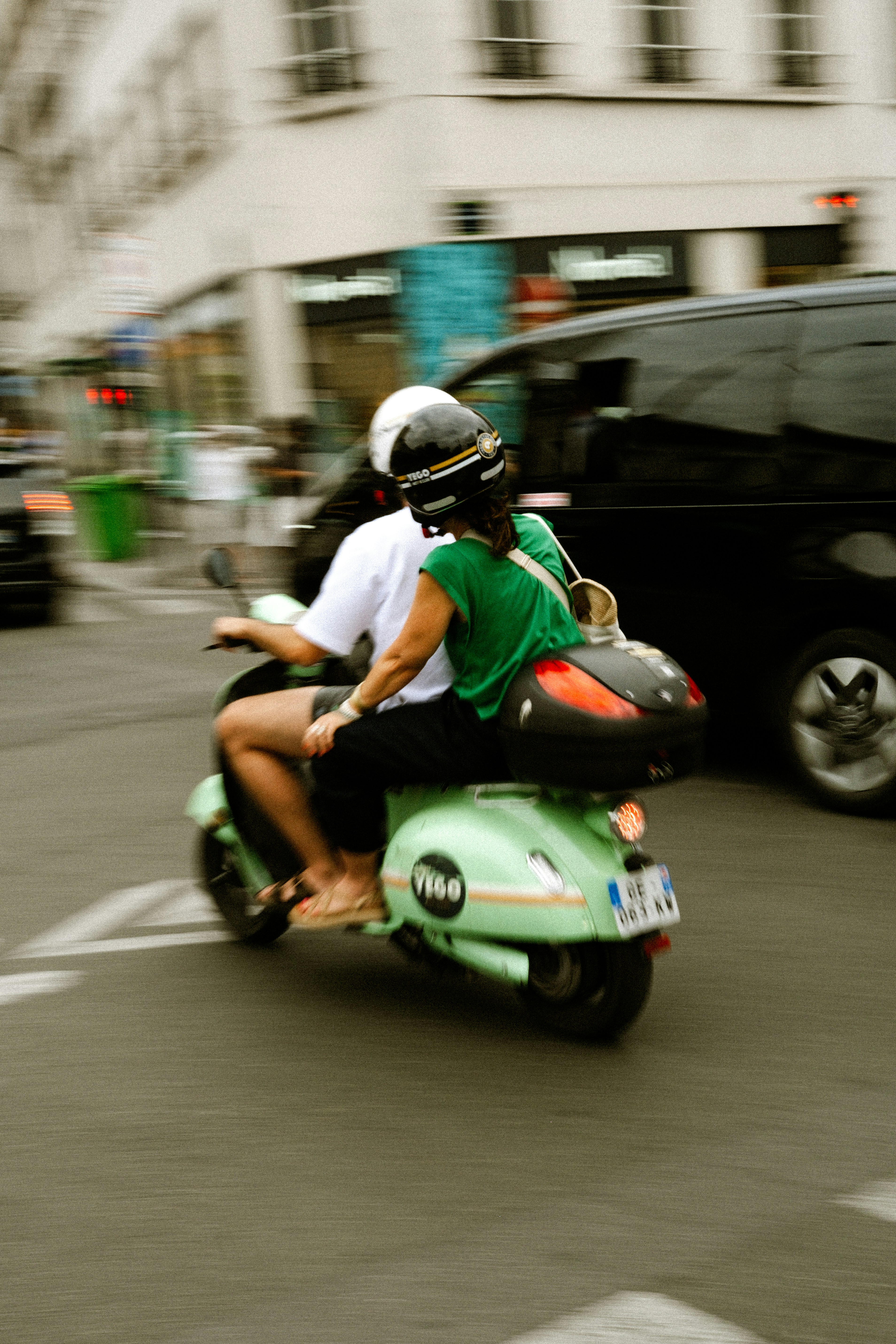 Two People Ride A Green Scooter On A City Street. HD mobile wallpaper