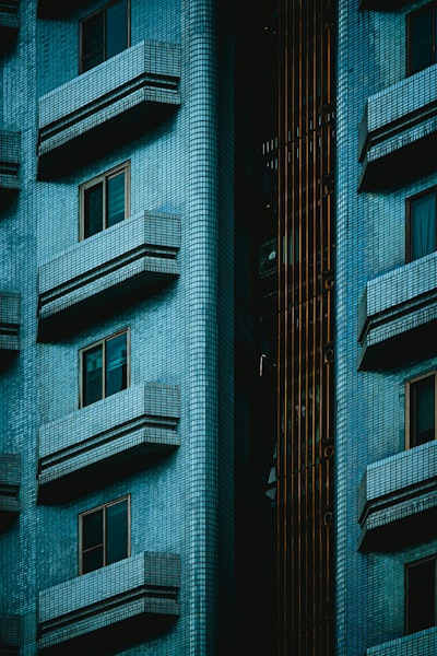 Rows Of Balconies On A Blue Tiled Building Exterior. wallpaper preview