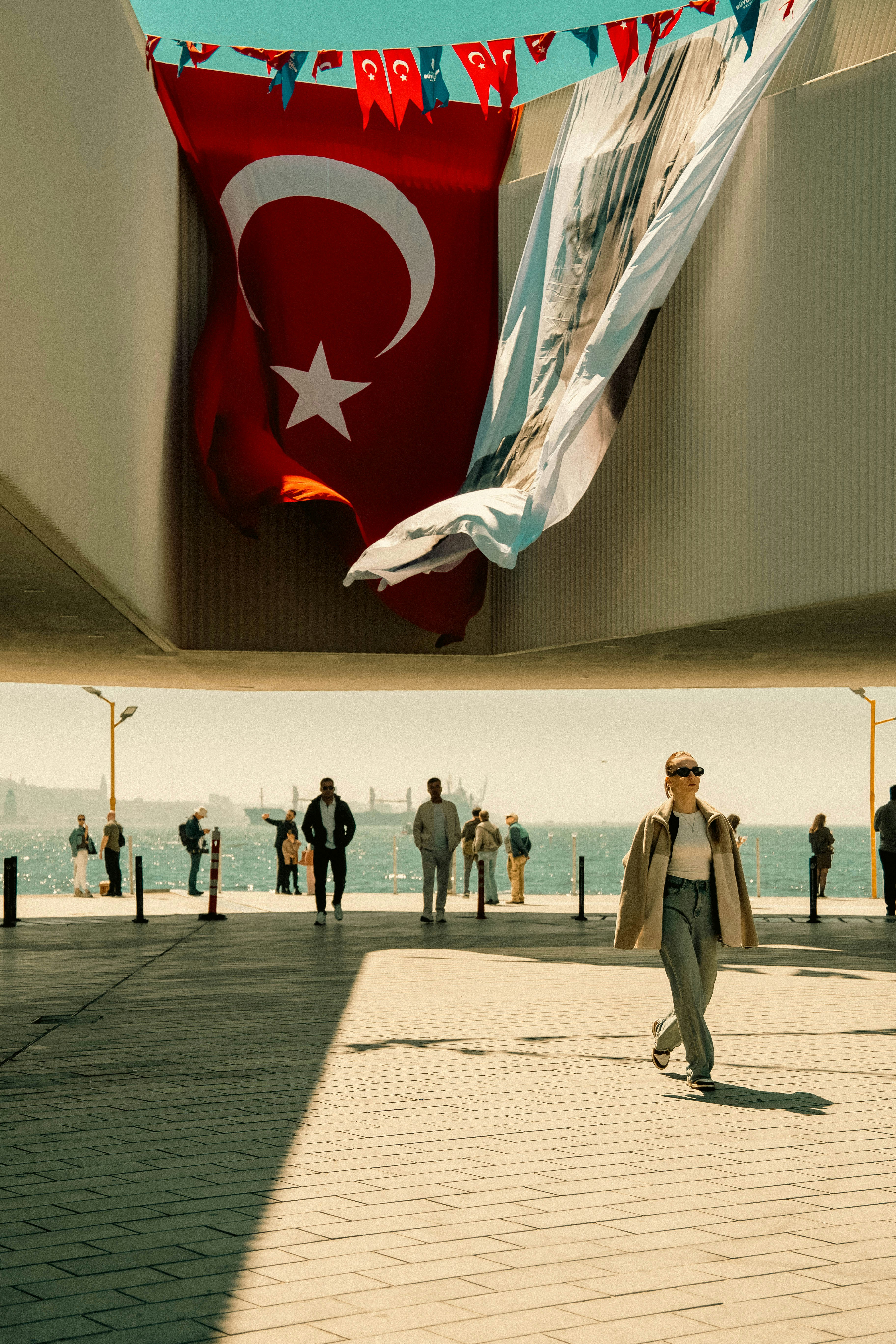 Woman Walks Under A Large Turkish Flag By The Sea. HD mobile wallpaper