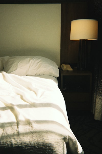 Unmade Bed With Sunlight Streaming Across The Sheets. wallpaper preview