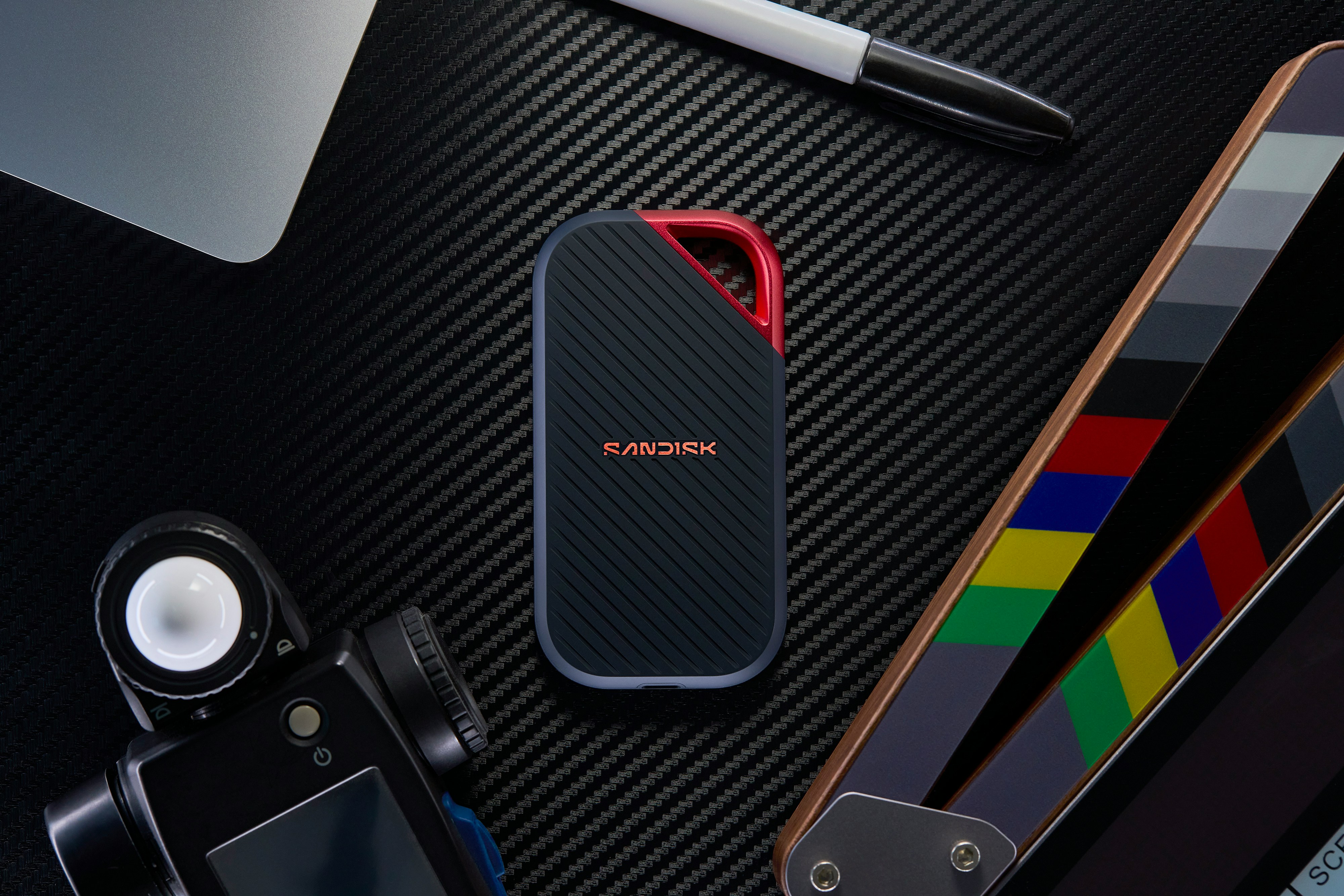 Portable Ssd, Camera, Clapperboard, And Laptop On A Dark Surface. HD mobile wallpaper