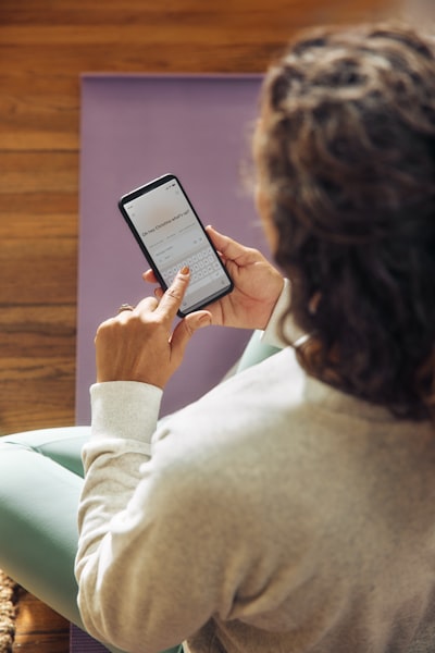 Woman Using A Smartphone On A Yoga Mat. wallpaper preview