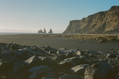 A Rocky Beach With Sea Stacks And A Towering Cliff. wallpaper preview