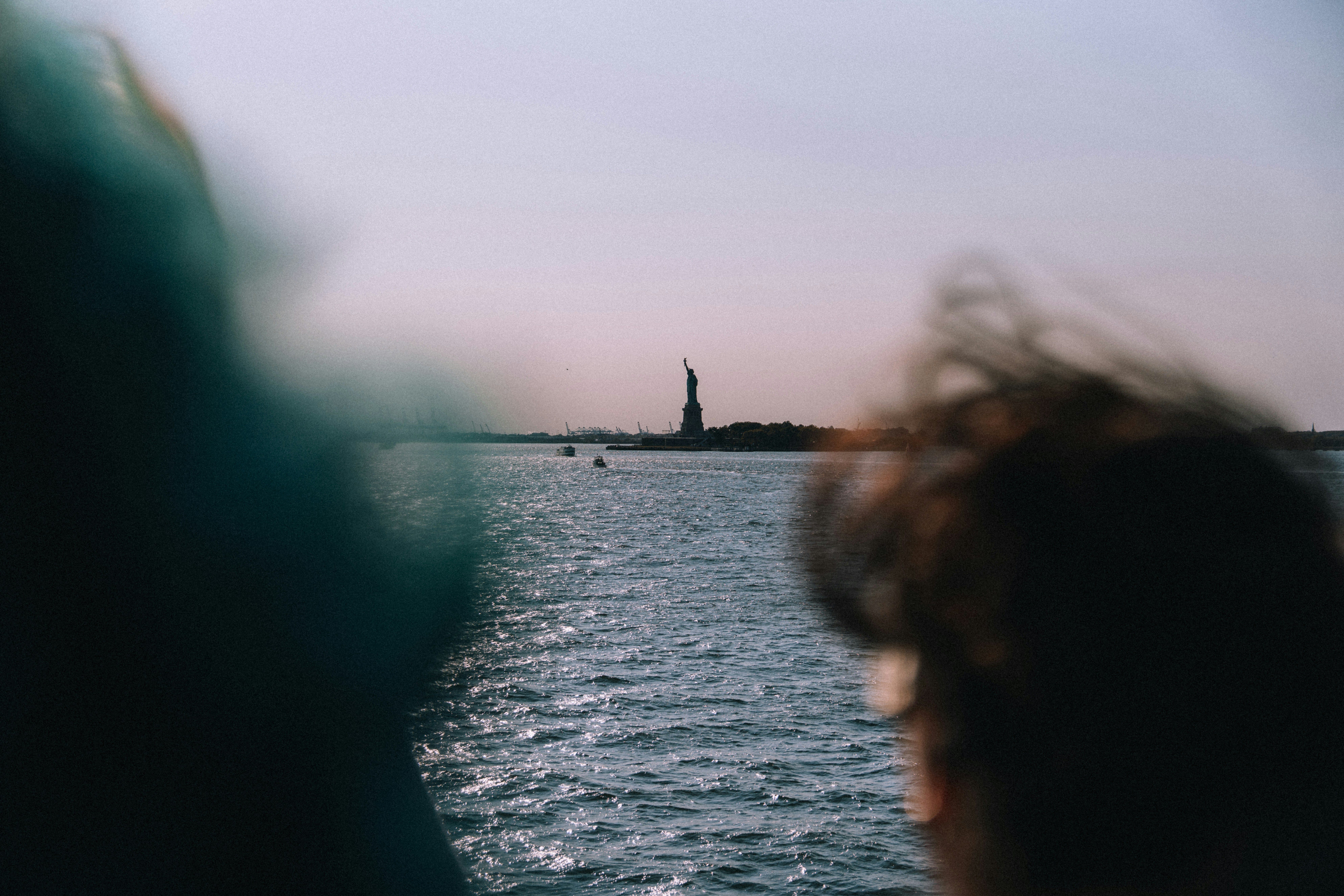 Statue Of Liberty Seen Across Sparkling Water. HD mobile wallpaper