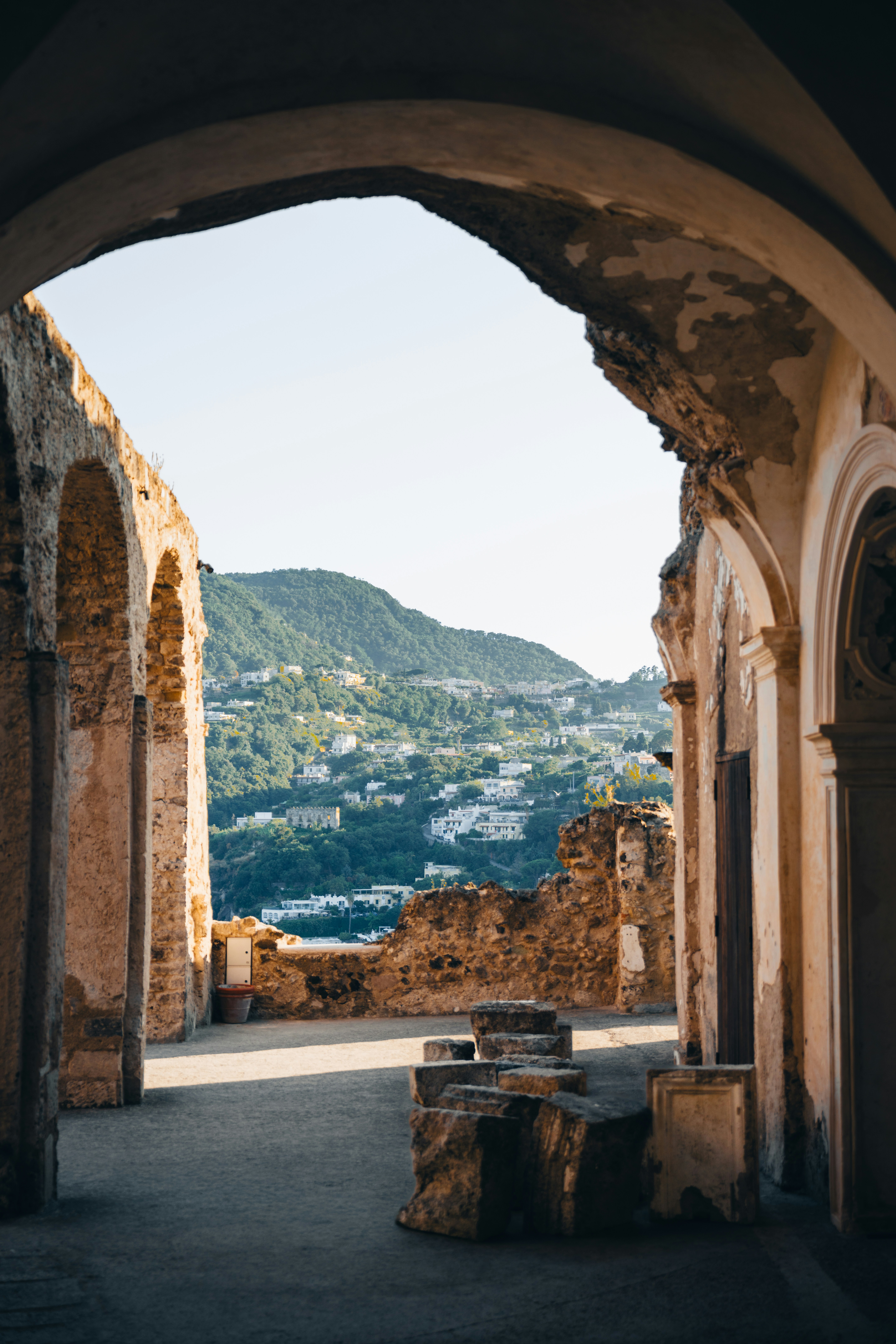 Ancient Archway Frames A Distant Town On A Hillside. HD mobile wallpaper