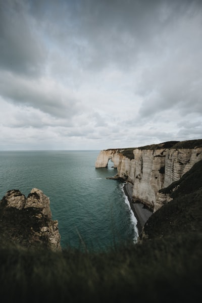 White Cliffs Meet The Ocean Under A Dramatic Cloudy Sky. wallpaper preview