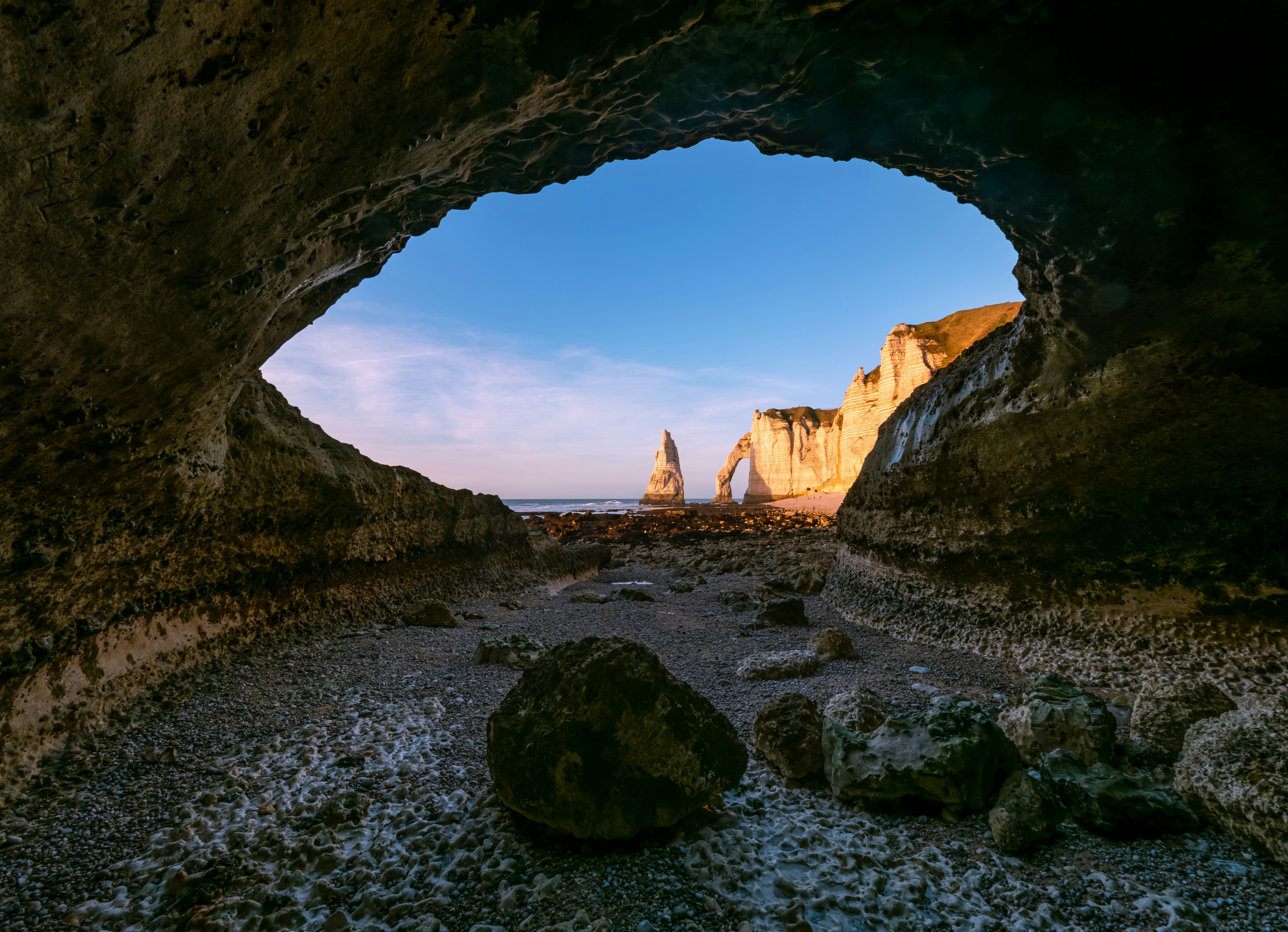 Sea Cave Entrance Framing Distant Cliffs And A Natural Arch. HD mobile wallpaper