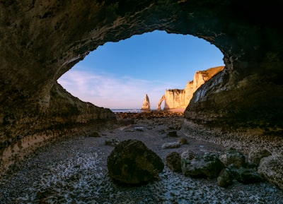 Sea Cave Entrance Framing Distant Cliffs And A Natural Arch. wallpaper preview