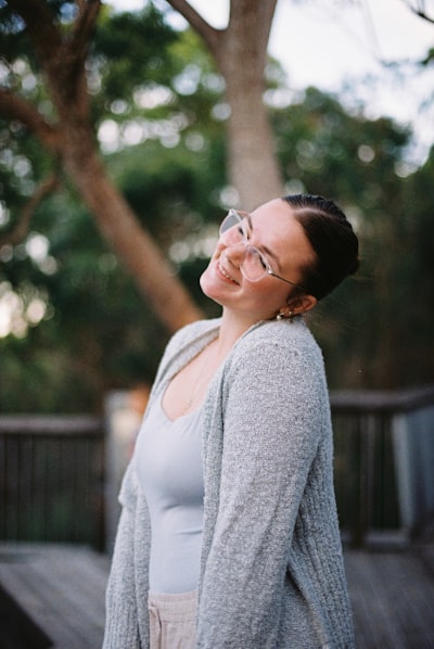 Smiling Young Woman With Braided Hair And Glasses Outdoors. wallpaper preview