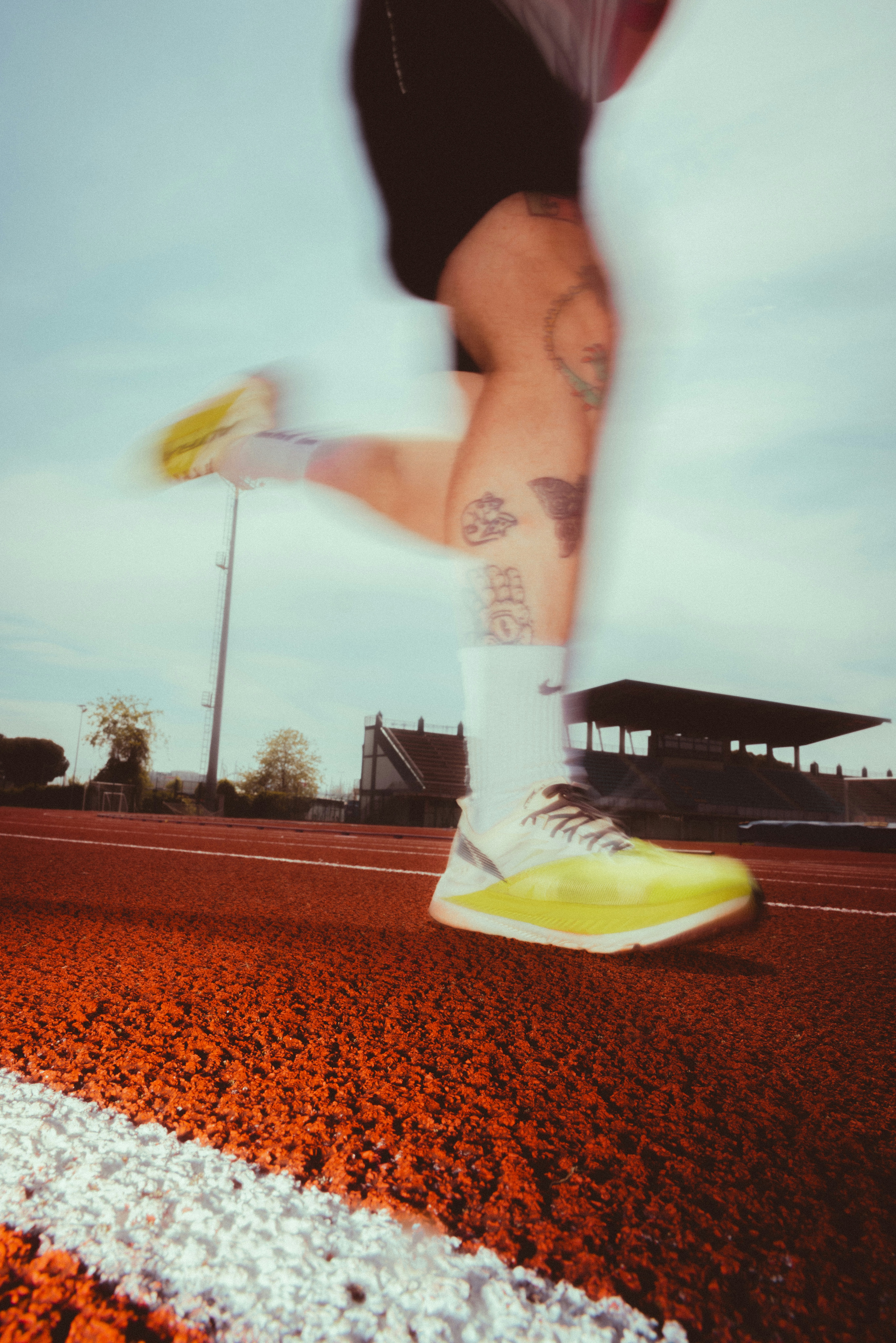 Tattooed Legs, Neon Kicks, Blurred Stride; That's Real Track Day Energy. HD mobile wallpaper