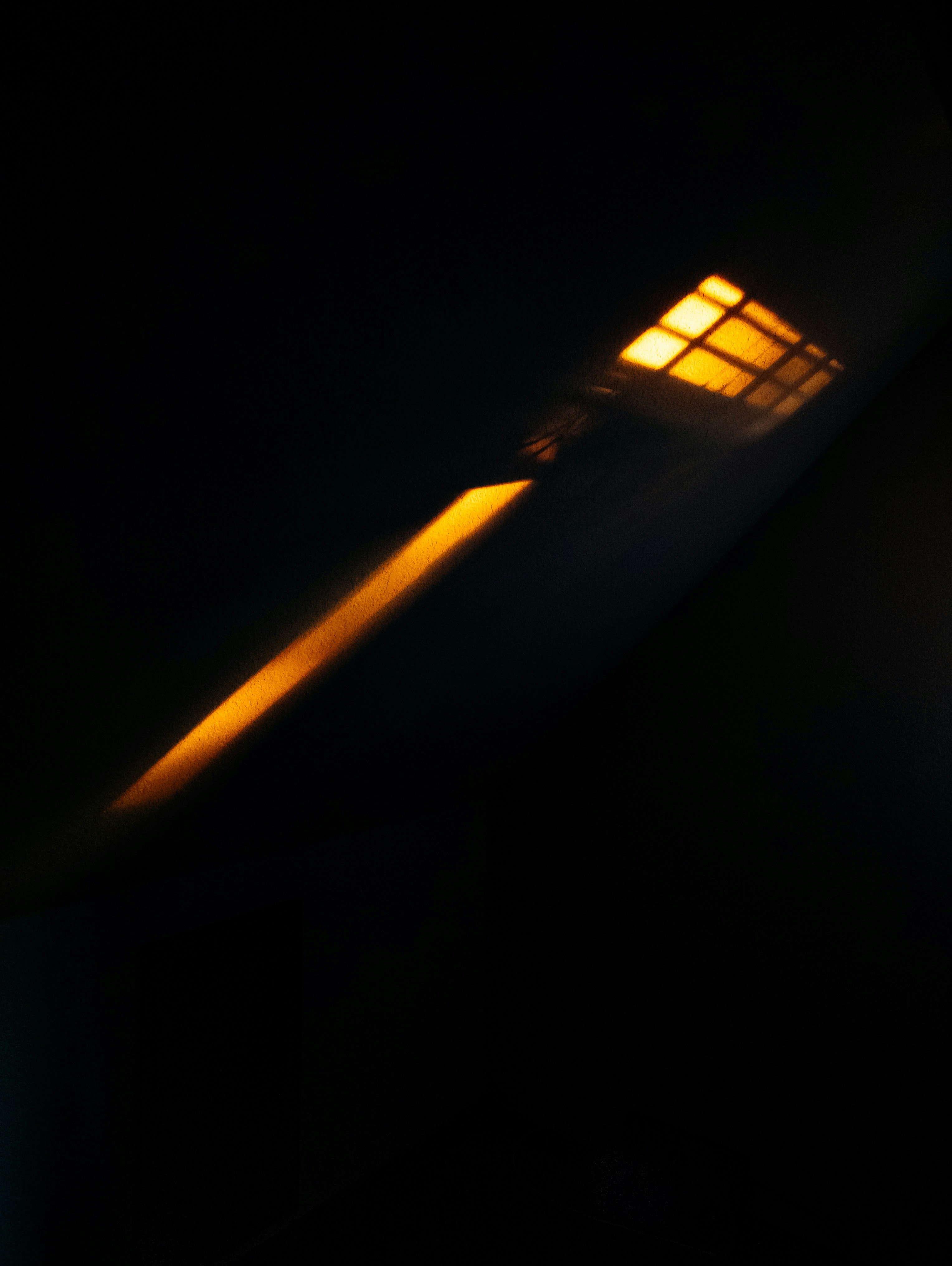 A Single Light Source Casts A Bright Orange Glow HD mobile wallpaper