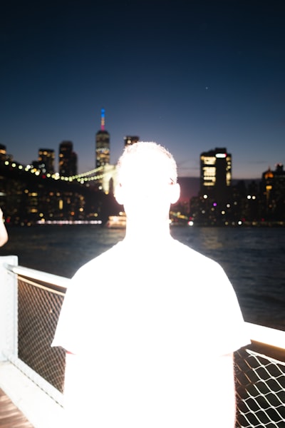 A Person Views A Vibrant Cityscape And Bridge At Night. wallpaper preview
