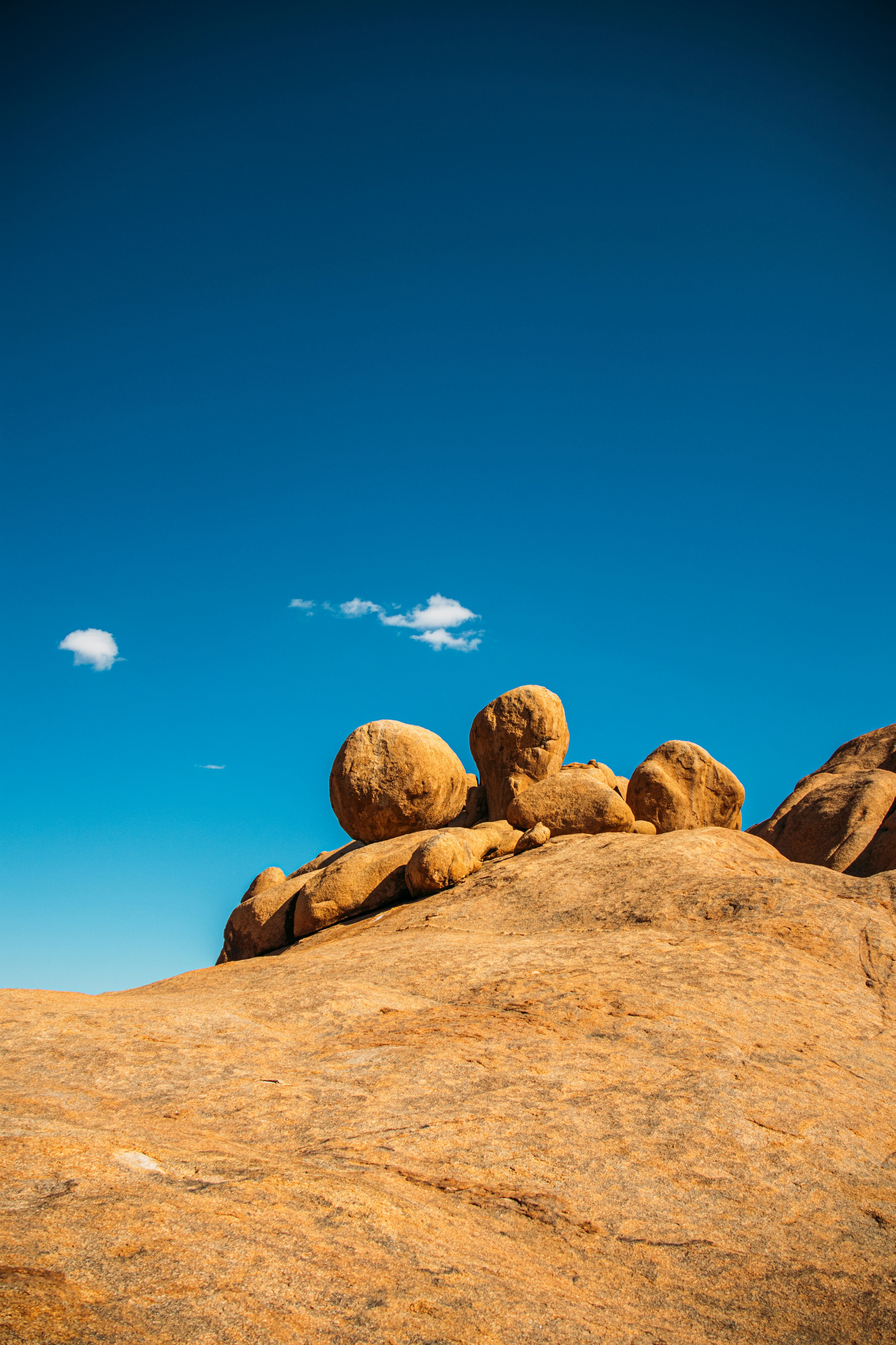 Massive Rock Formations Under A Clear Blue Sky. HD mobile wallpaper