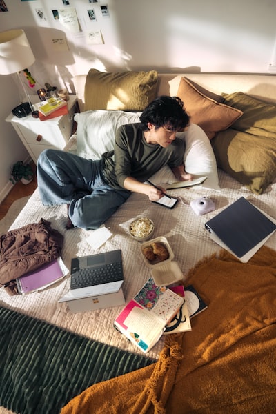 Young Man On Bed With Laptop And Snacks wallpaper preview