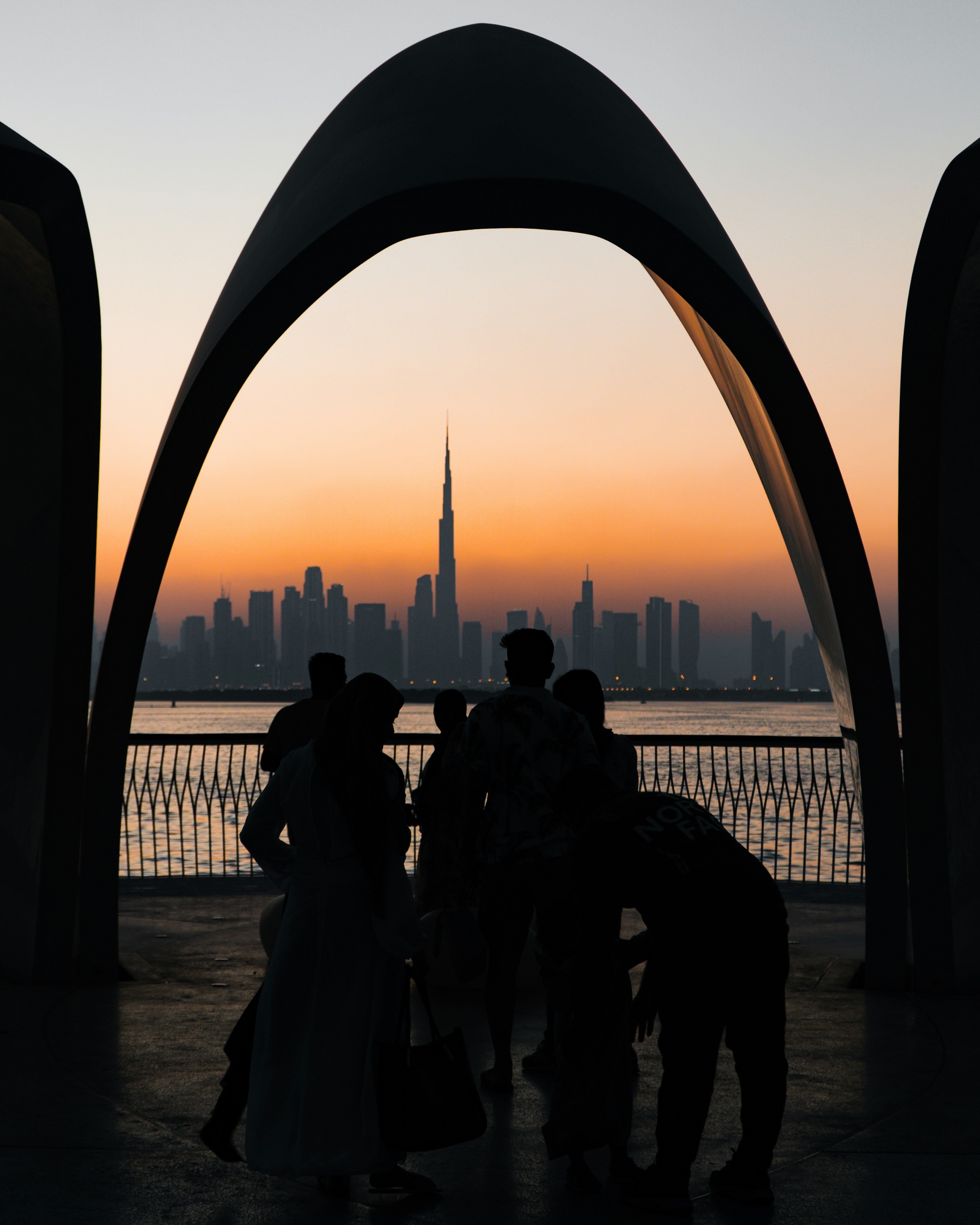 Silhouettes Watch Sunset Over Dubai Skyline And Burj Khalifa. HD mobile wallpaper