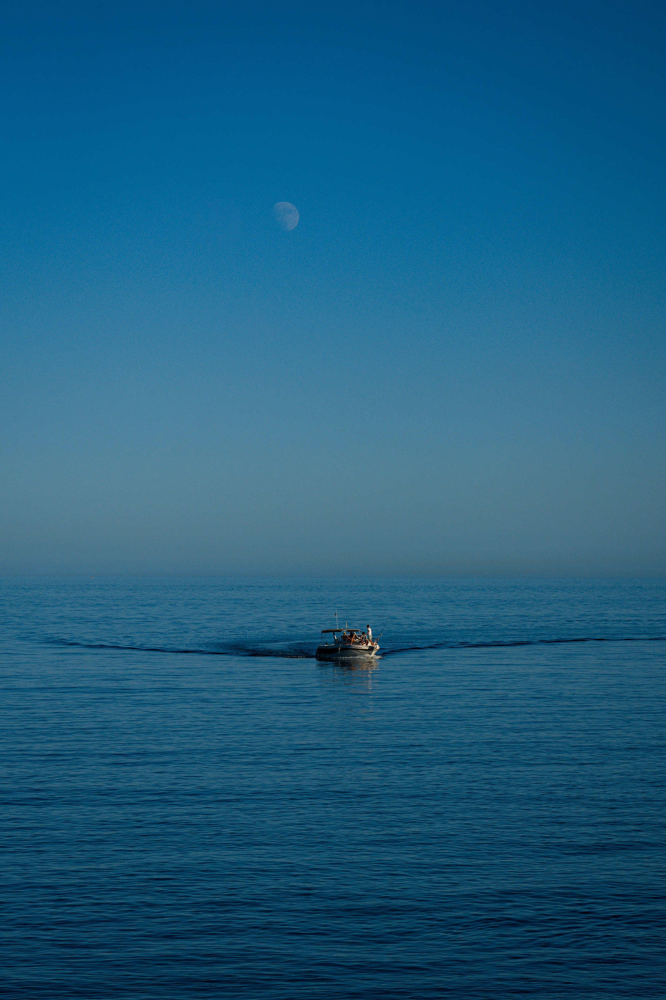 Boat On Calm Blue Ocean With Crescent Moon In Sky. HD mobile wallpaper