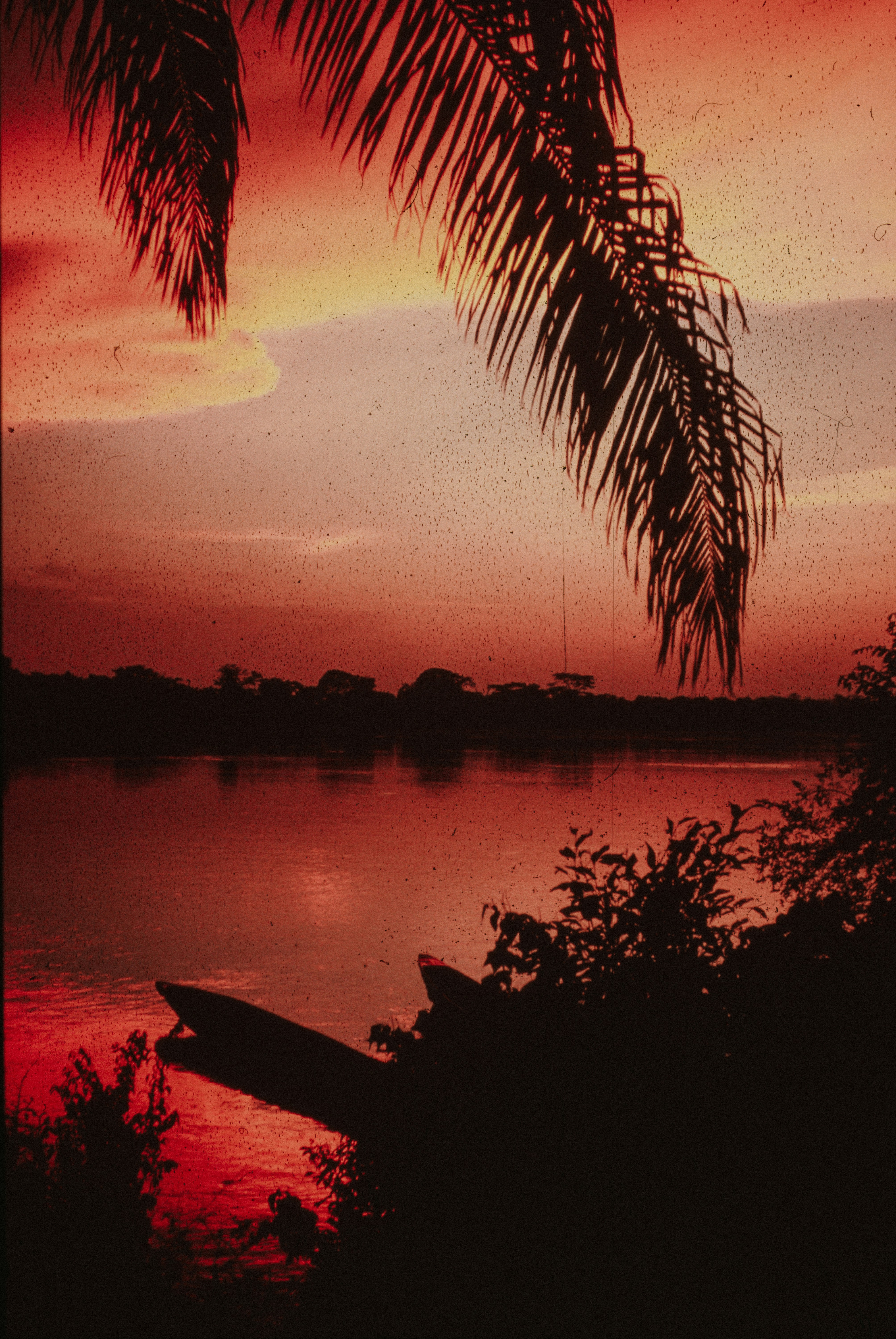 Red Sunset Over A Calm River With A Silhouetted Boat. HD mobile wallpaper