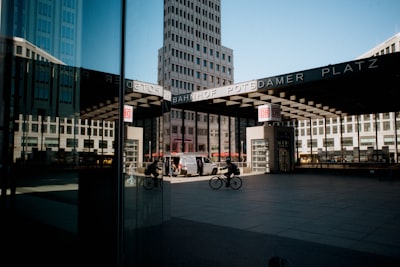 Bicyclists Ride Through A Modern City Square. wallpaper preview