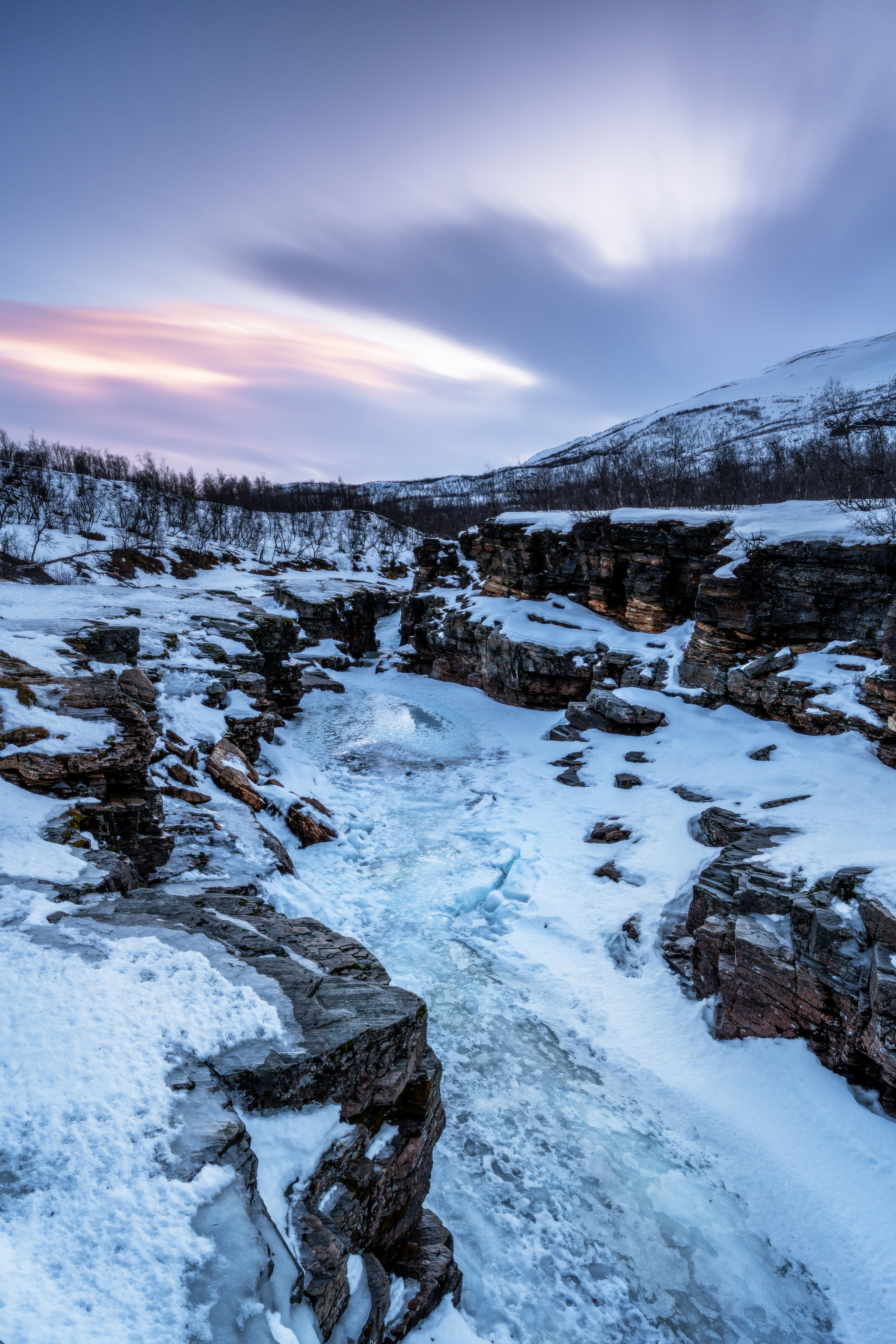 Icy River Winding Through A Snow-covered Canyon At Dusk. HD mobile wallpaper