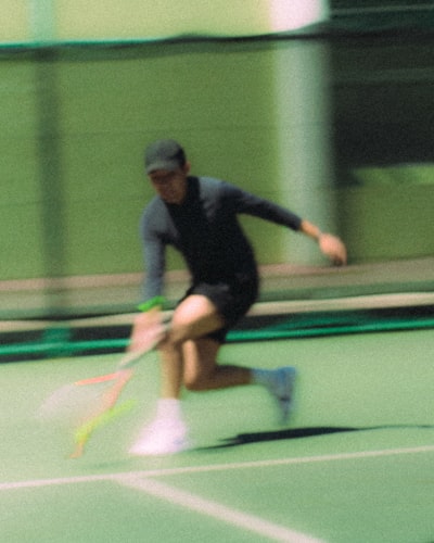 Tennis Player In Motion On A Green Court. wallpaper preview