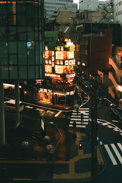 Rainy City Street At Night With Illuminated Buildings. wallpaper preview