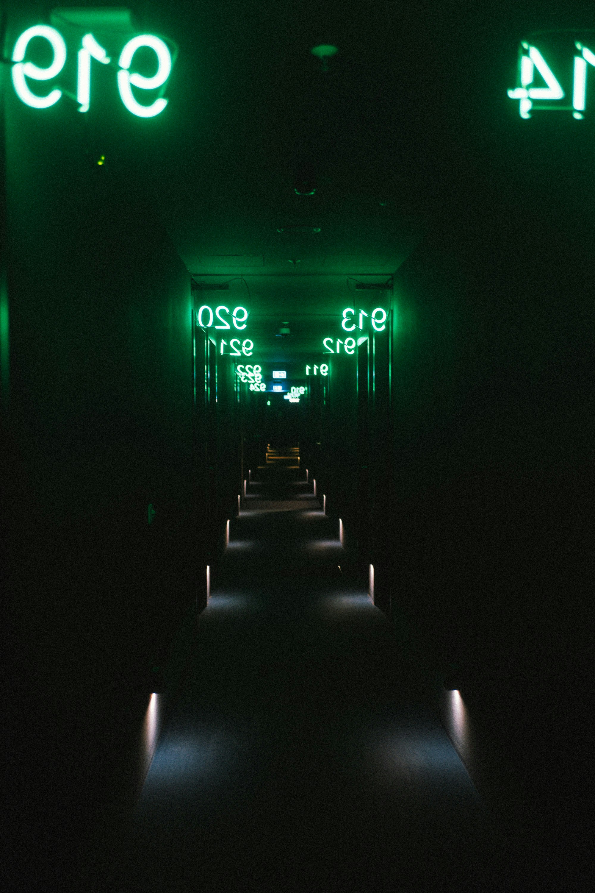 A Dark Hallway With Green Neon Signs And Illuminated Floor. HD mobile wallpaper