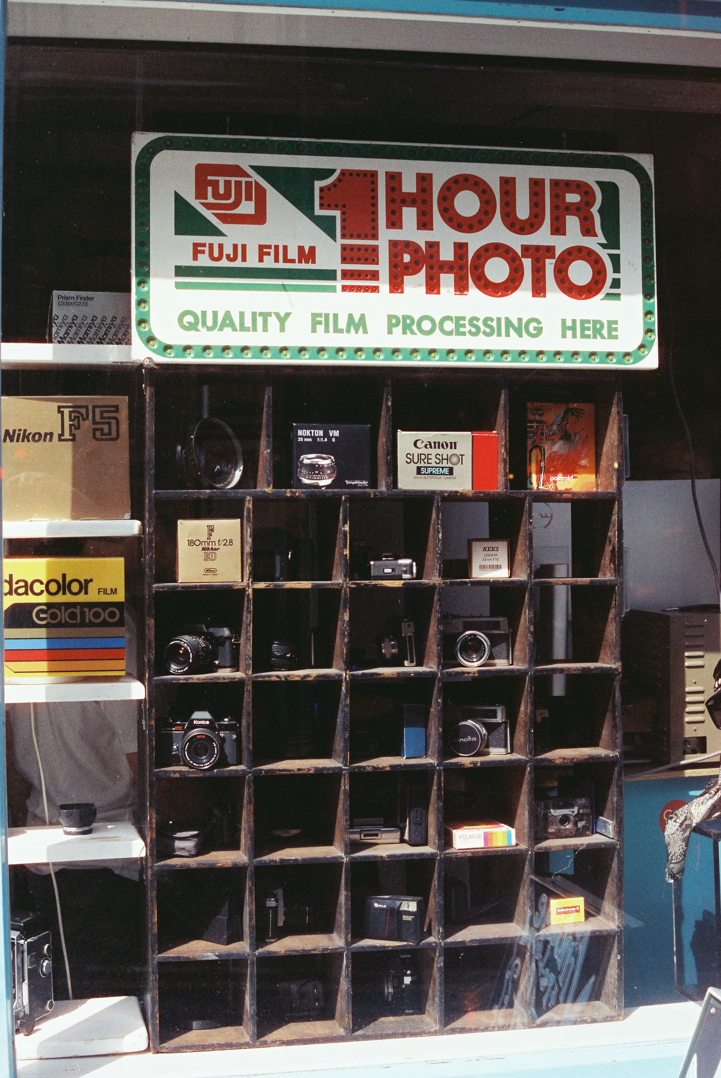 Fuji Film 1 Hour Photo Sign Above Cameras In Window. HD mobile wallpaper