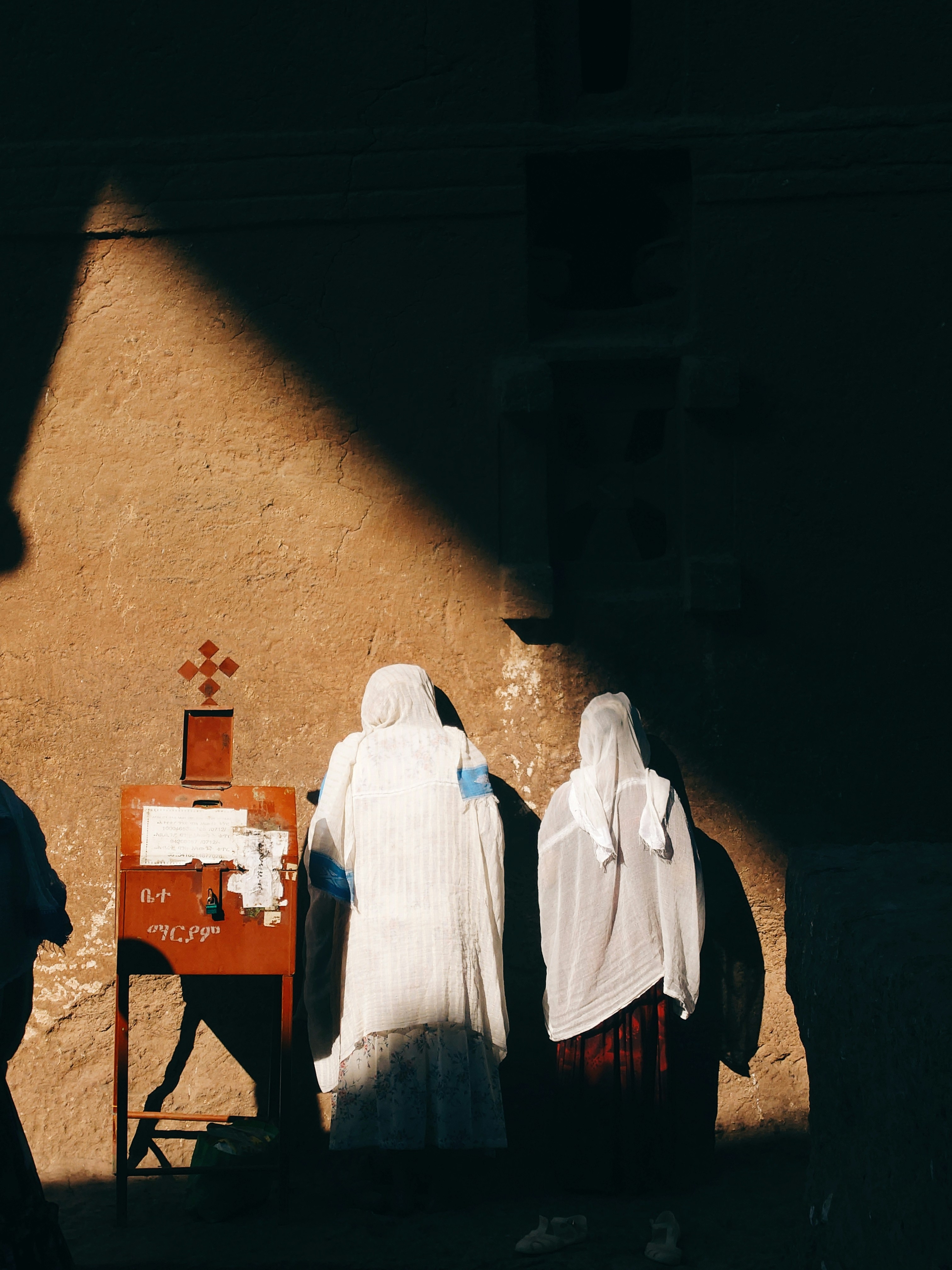 Two Robed Women Stand Near A Cross In Sunlight. HD mobile wallpaper