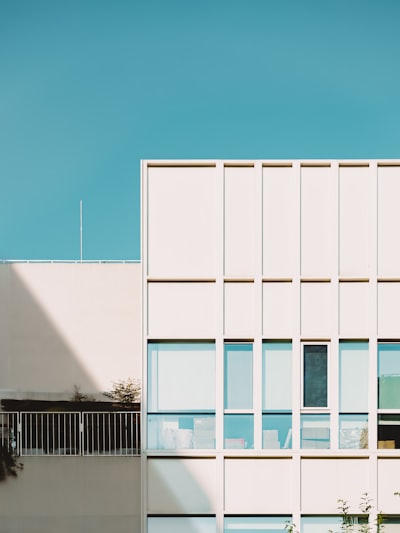 Modern White Building With Windows Under A Clear Blue Sky. wallpaper preview