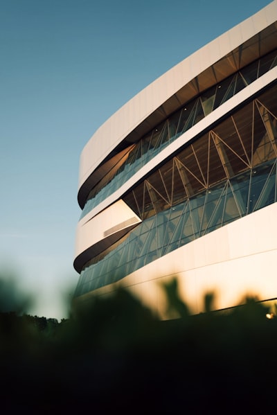 Modern Curved White Building With Geometric Windows Under Blue Sky. wallpaper preview