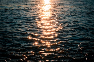 Sunlight Path Reflecting On Dark, Rippling Ocean Water At Sunset. wallpaper preview