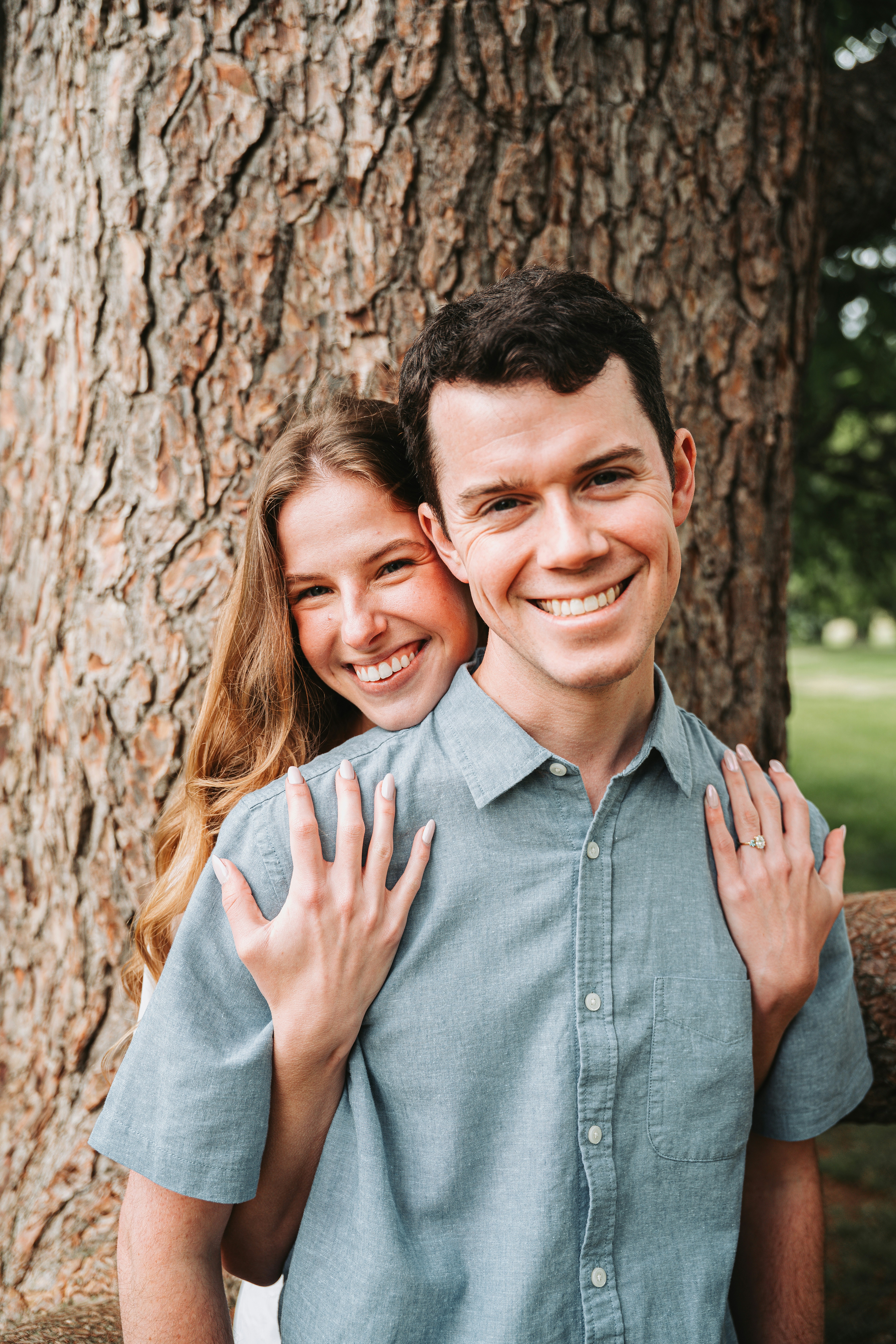 A Smiling Couple Embraces In Front Of A Tree. HD mobile wallpaper