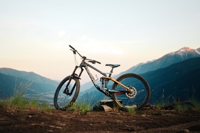 Mountain Bike Parked On A Trail With Mountains At Sunset. wallpaper preview