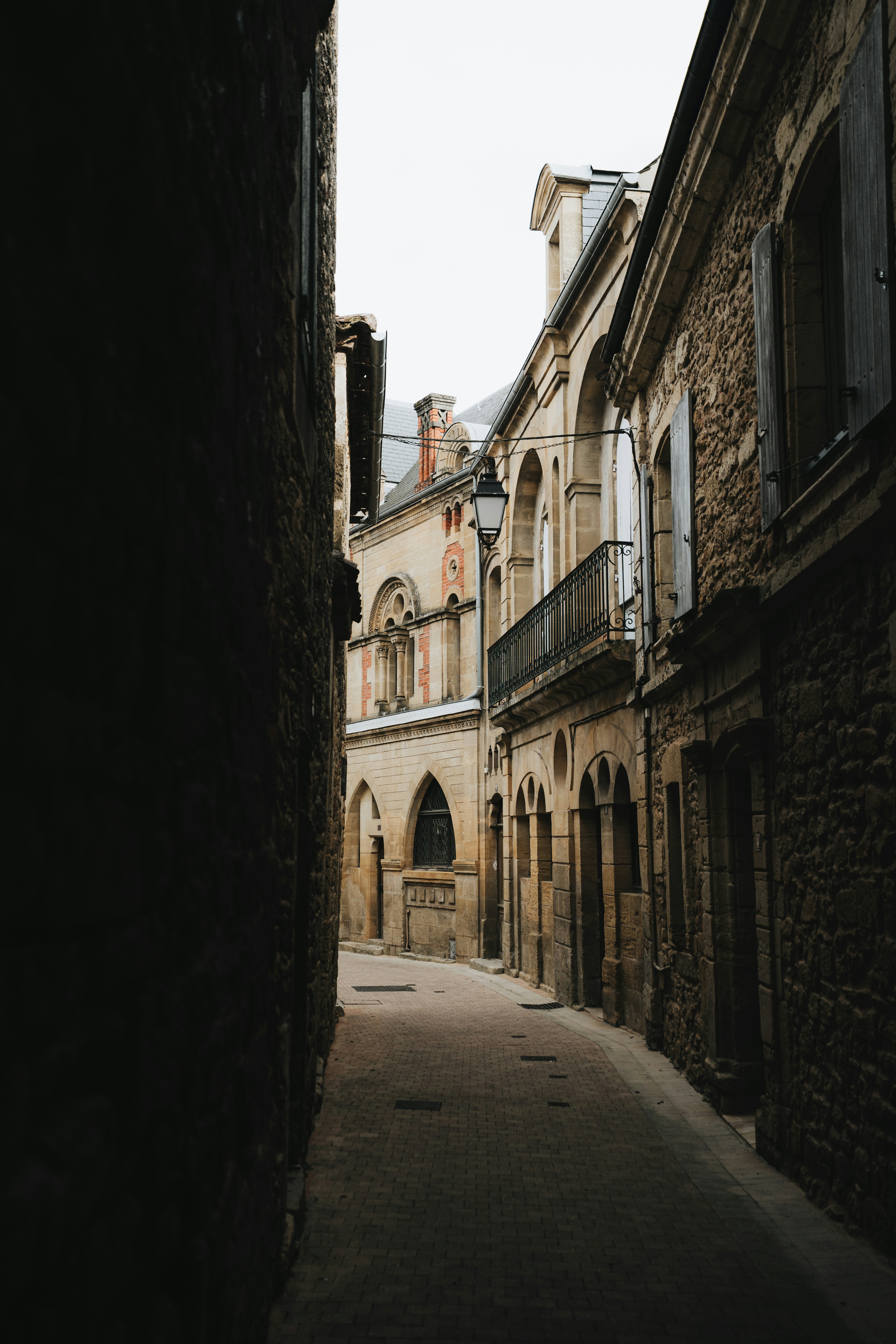Old Stone Buildings Line A Narrow, Shadowed European Street. HD mobile wallpaper