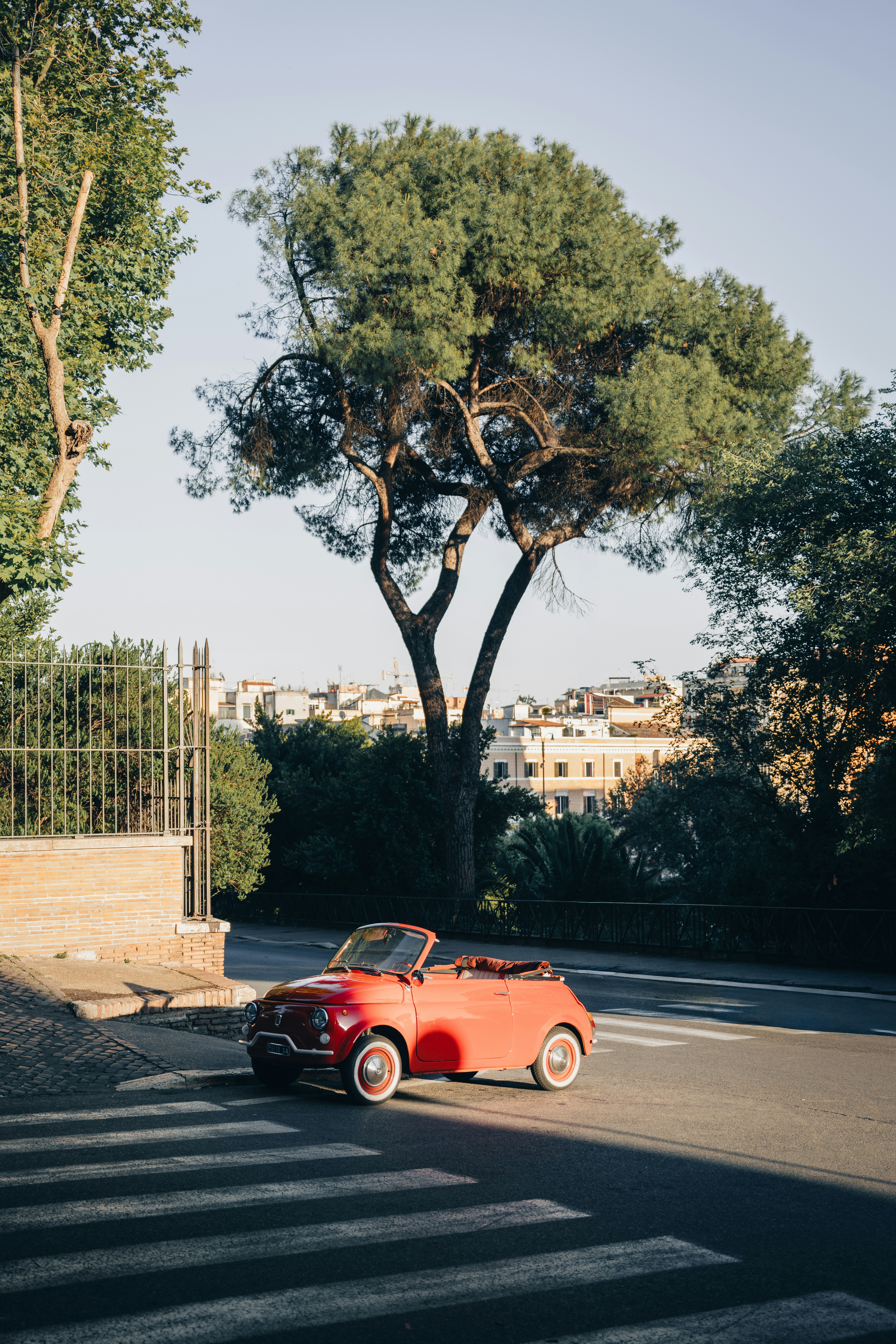 Vintage Red Convertible Car Parked On A Sunny City Street. HD mobile wallpaper