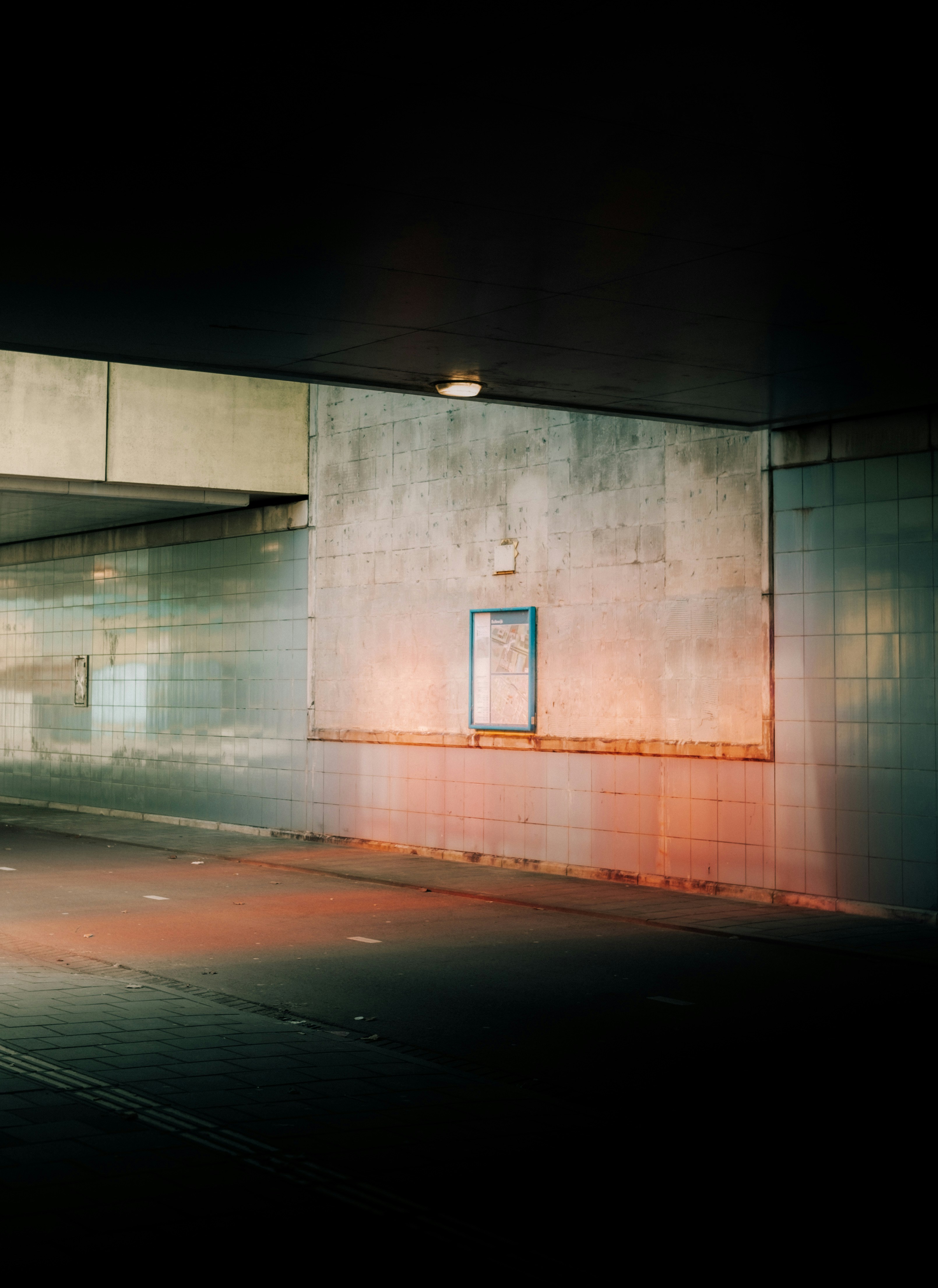 Dark Underpass With Concrete Walls And A Small Illuminated Sign. HD mobile wallpaper