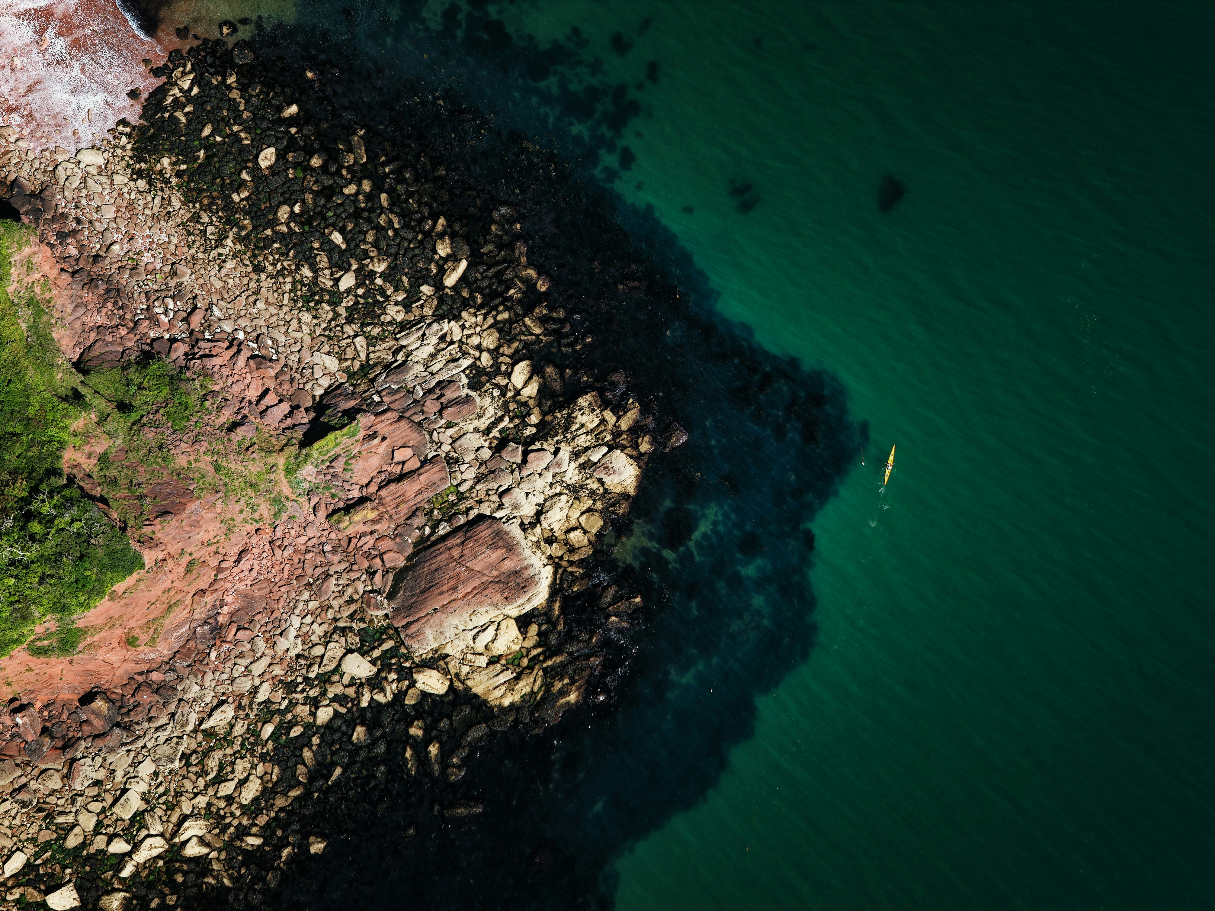 A Single Yellow Kayak Tracing The Coast Along The Shallows Of Babbacombe, Devon, UK HD mobile wallpaper