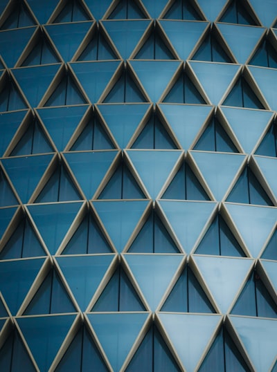 Geometric Blue Triangular Windows On A Modern Building Facade. wallpaper preview