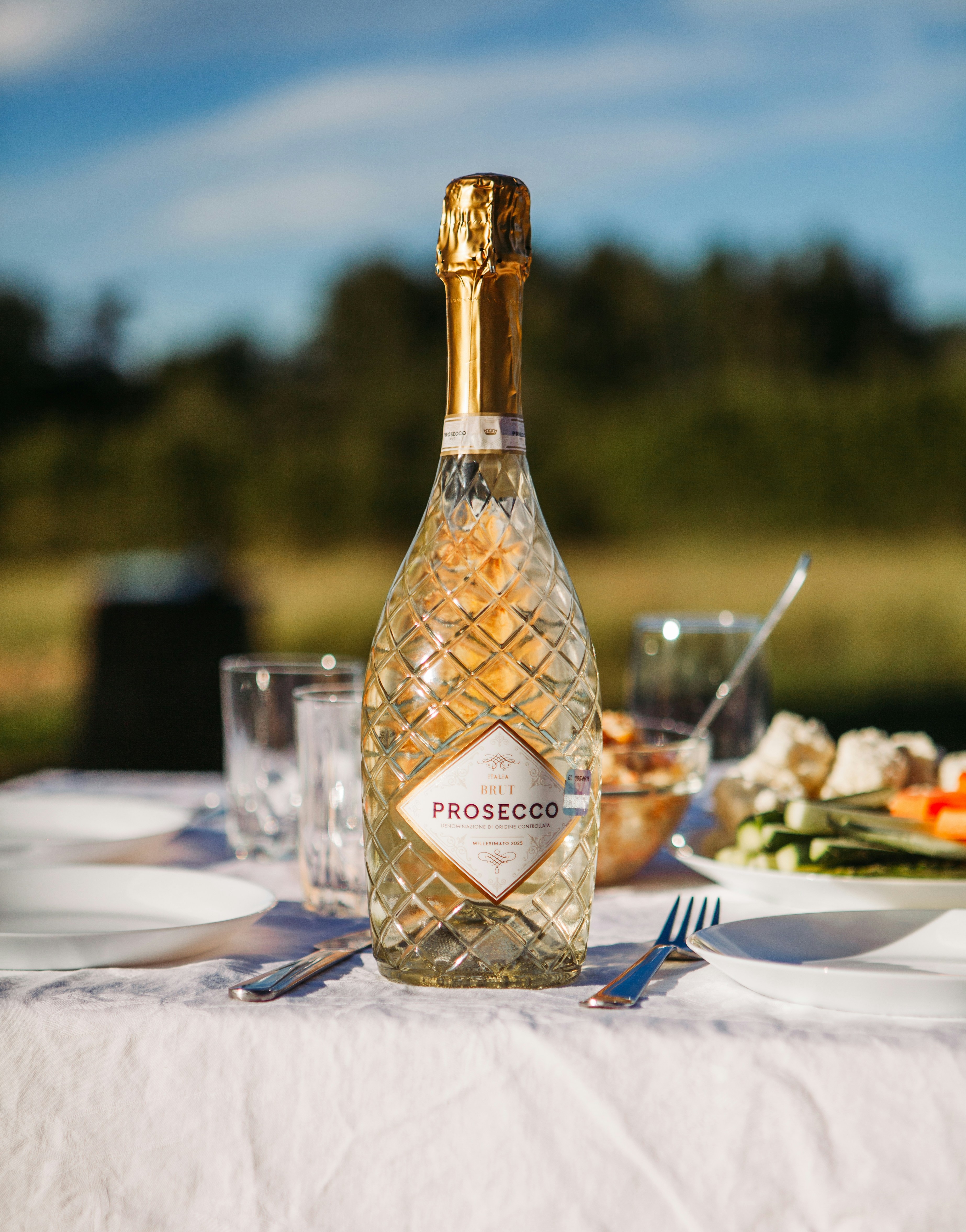 A Bottle Of Prosecco On A White Table Outdoors. HD mobile wallpaper