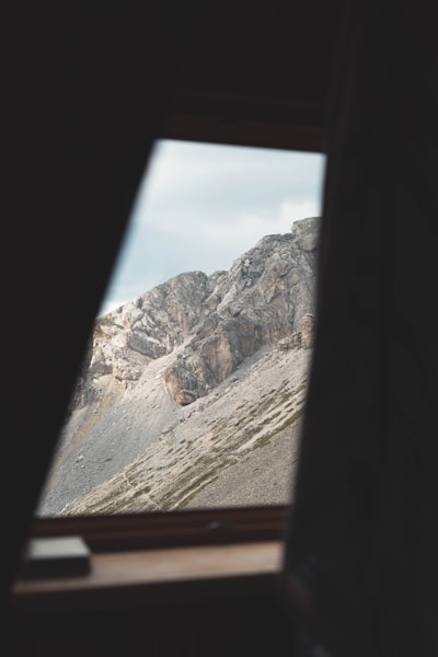 Rocky Mountain Peak Viewed Through A Dark Window Frame. wallpaper preview