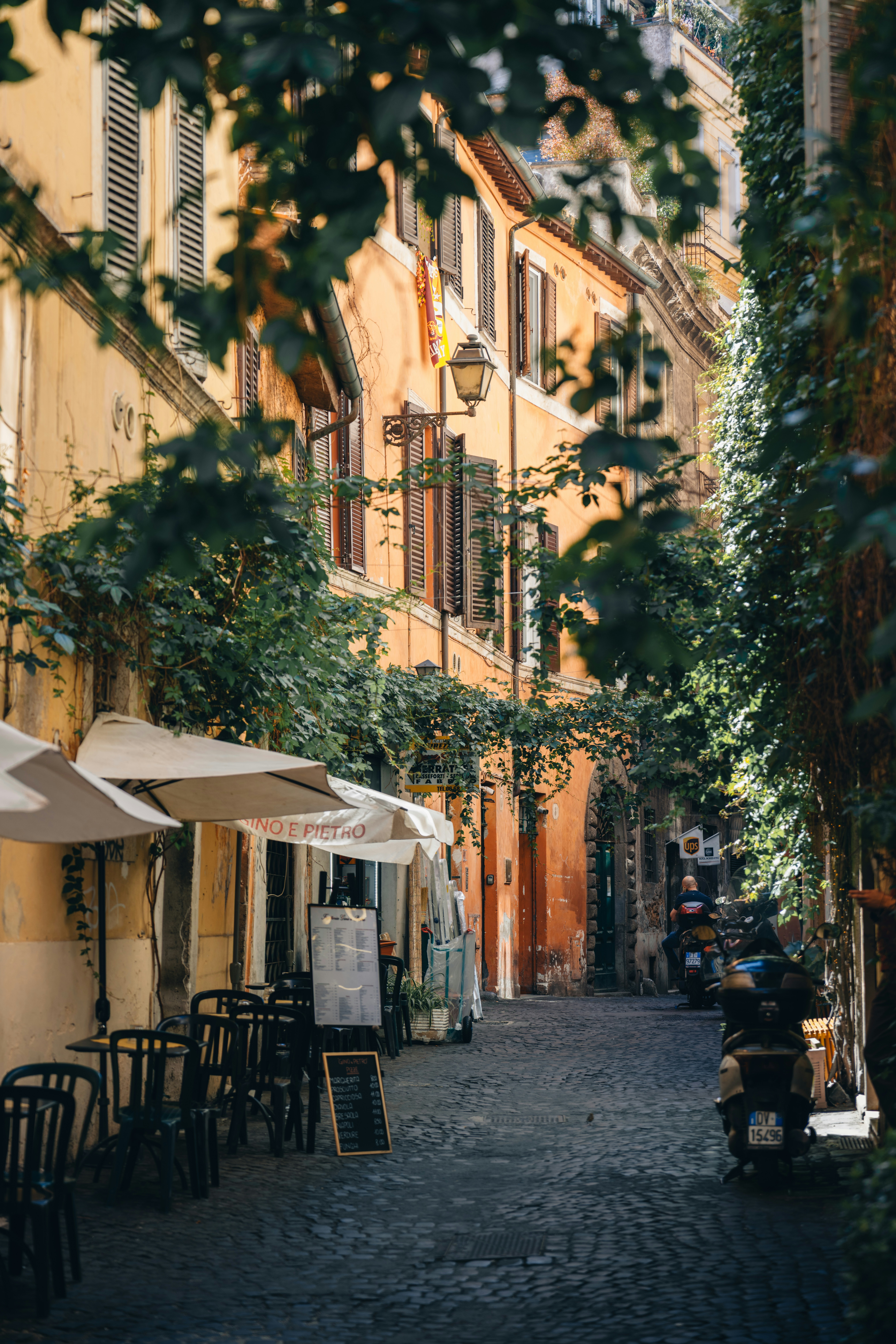 Charming Cobblestone Street With Cafes And Old Buildings. HD mobile wallpaper