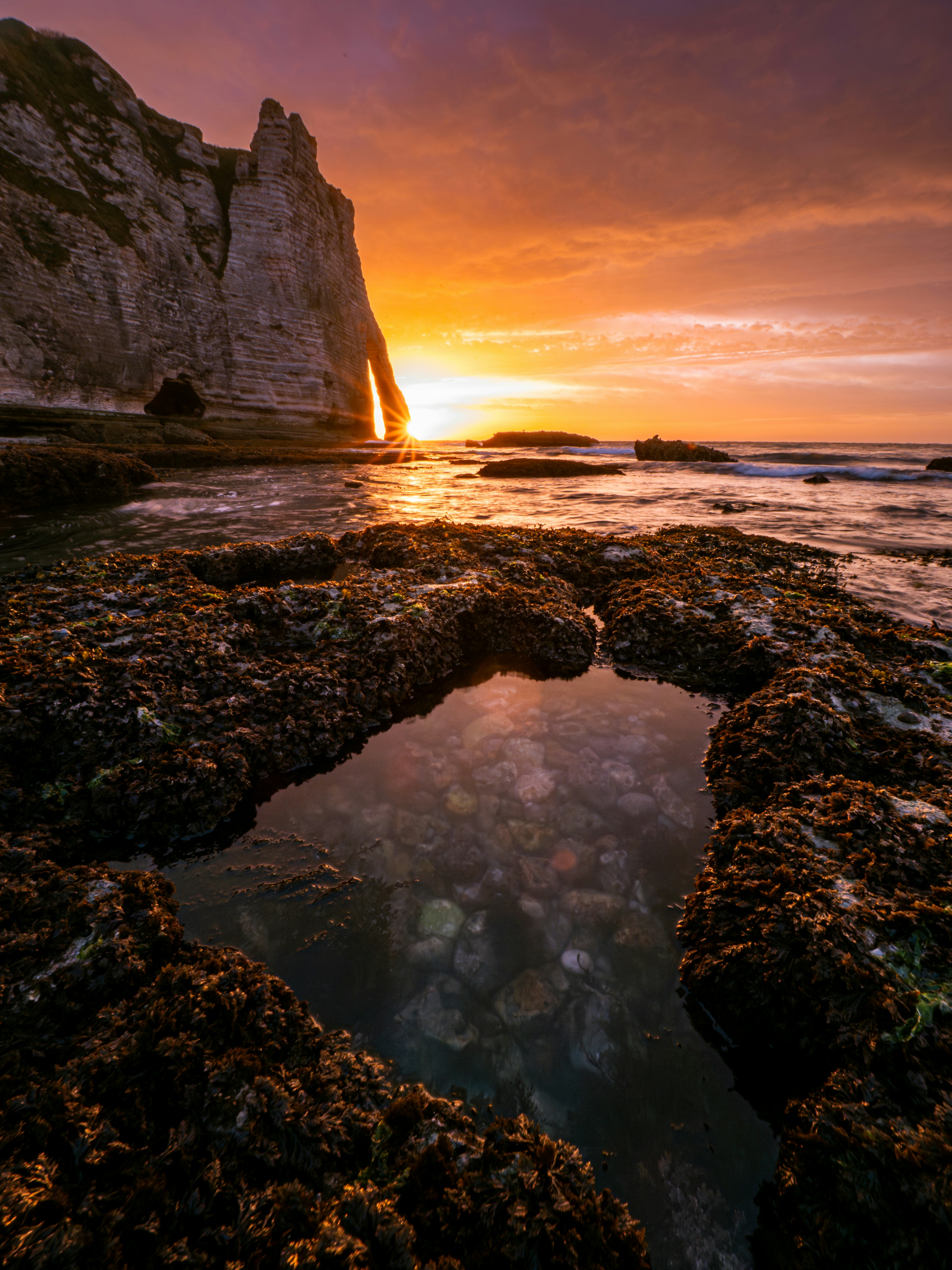 Vibrant Sunset Illuminates A Rocky Arch And Tide Pools. HD mobile wallpaper